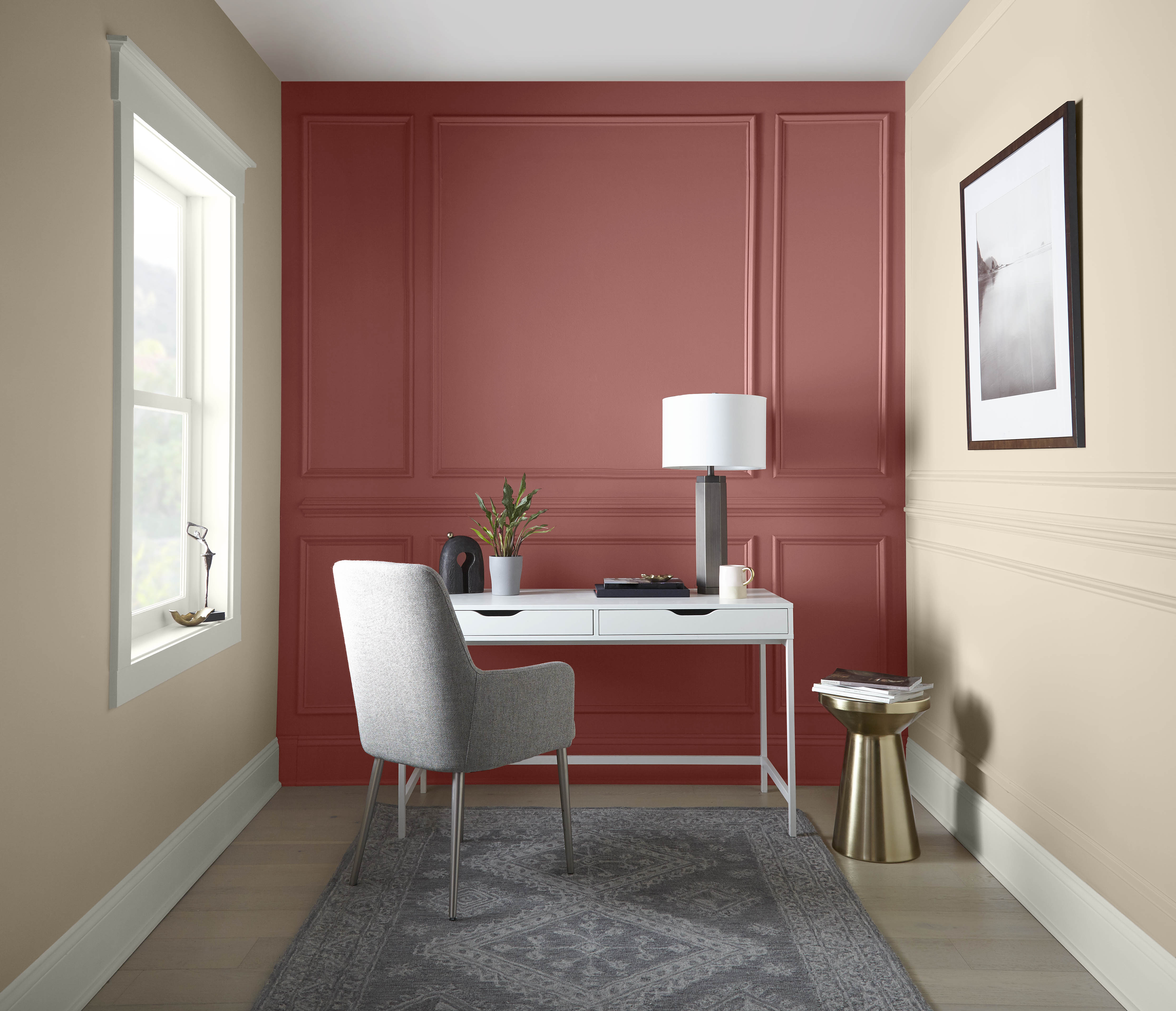 A home office with walls in the colour Spanish Sand and an accent wall in the colour Vermilion 