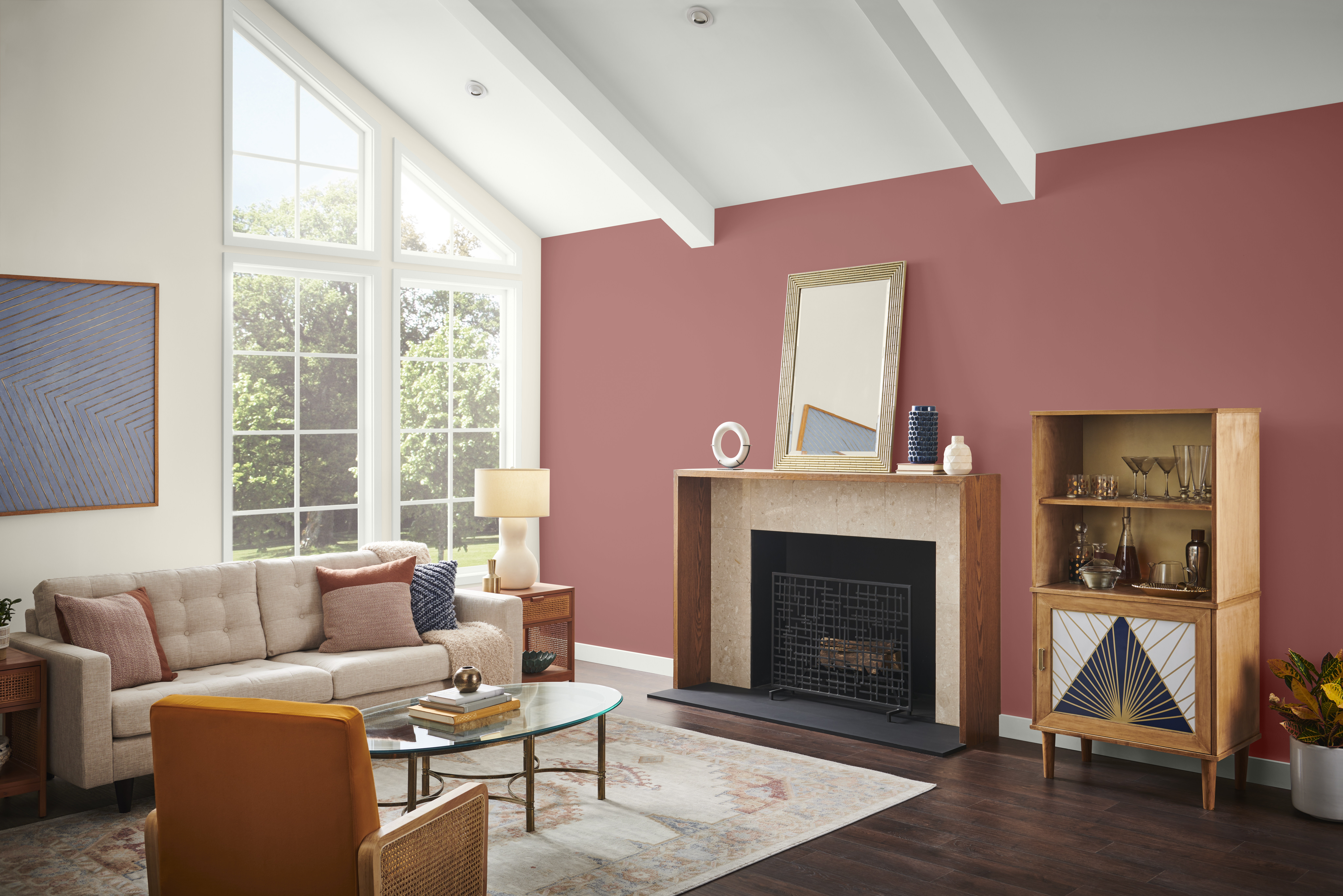 A living room with an accent wall in the colour Vermilion, styled with neutral furniture and décor 