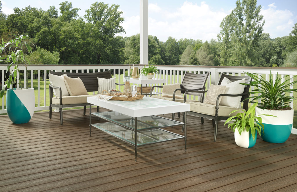 An outdoor patio styled with a table, chairs, and planters