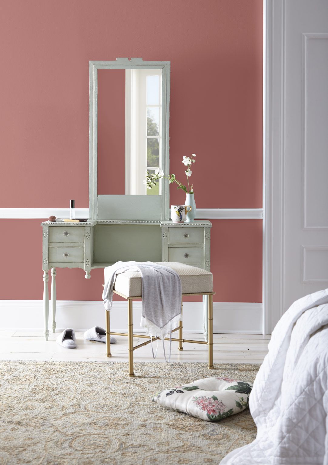A powder room with walls in the colour Vermilion and styled with a vintage vanity