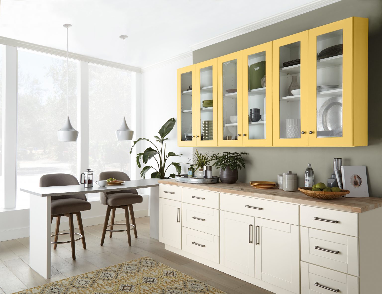 A bright and airy kitchen with cabinets in the colour Spirited Yellow