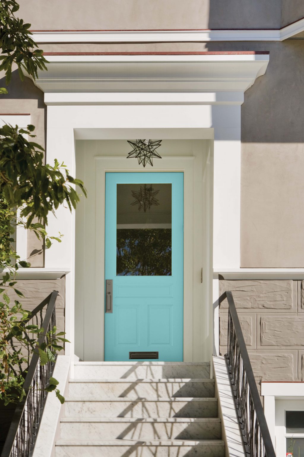 The exterior of a house with the front door painted in the colour Pure Turquoise