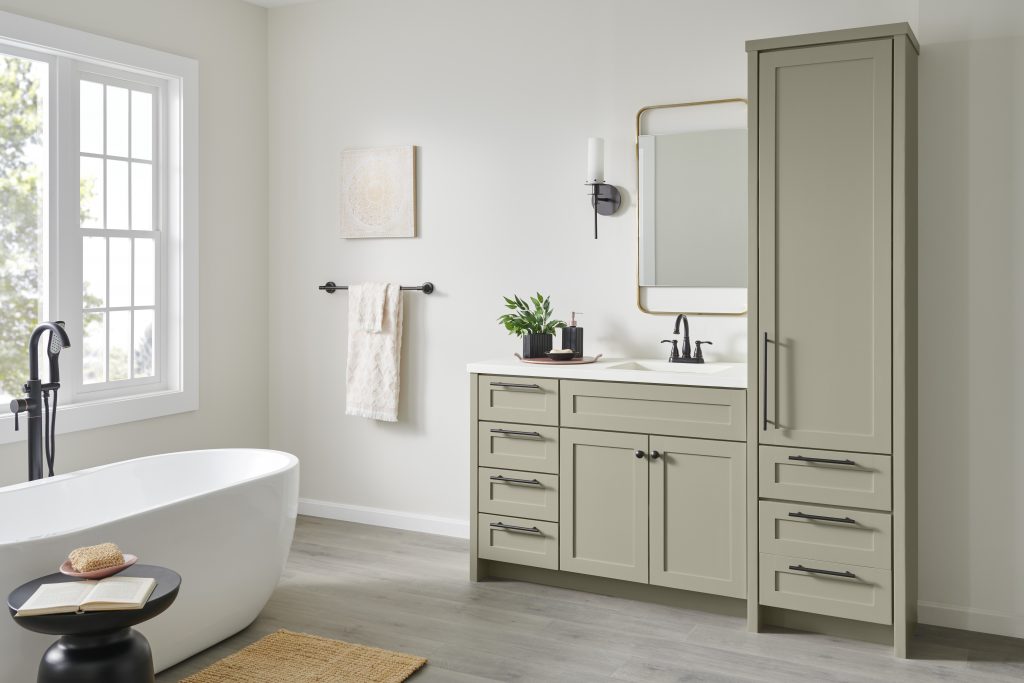 A bright and spacious bathroom with cabinets painted in the colour Jungle Camouflage and spray painted fixtures and accessories