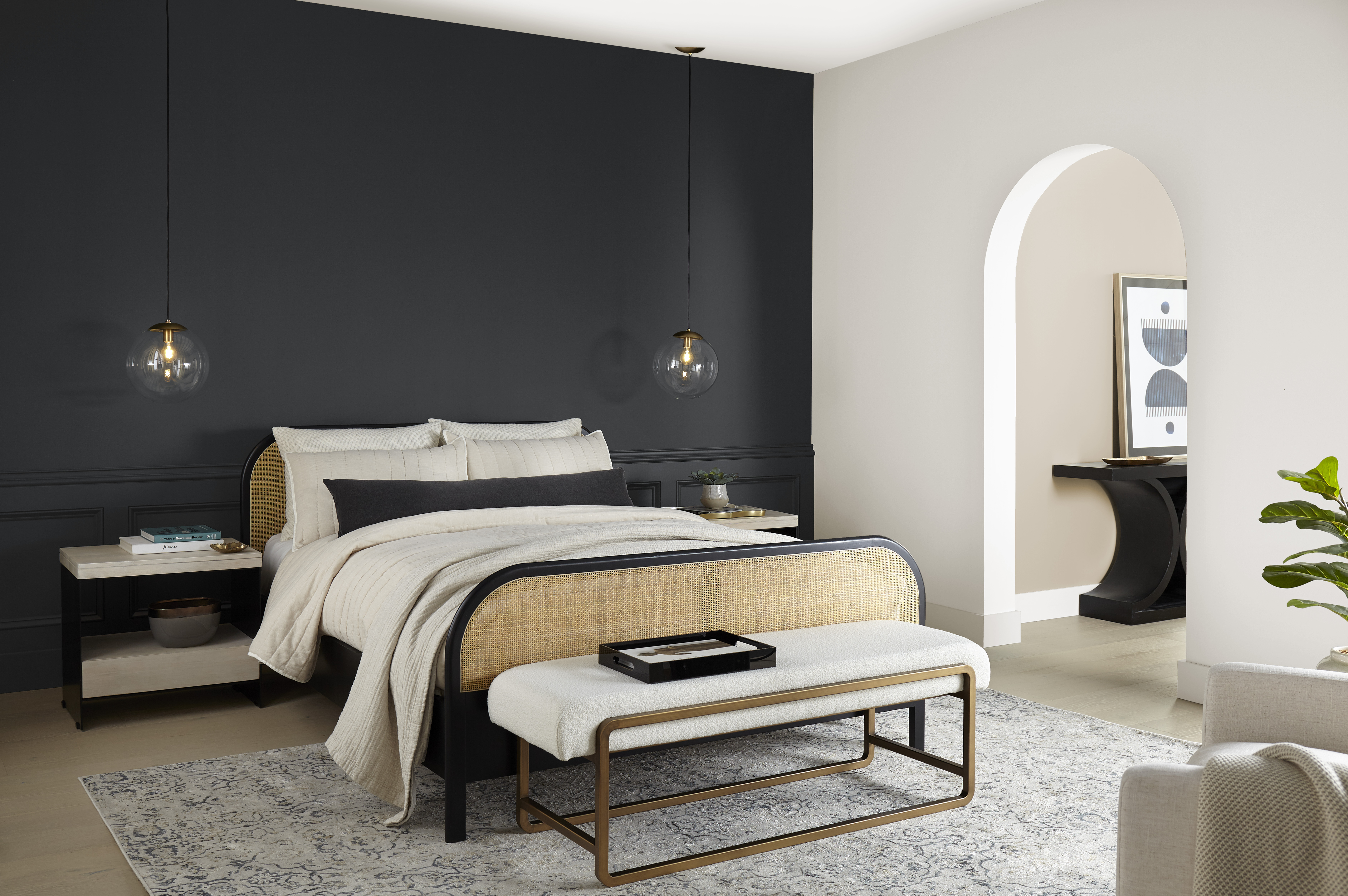 A modern bedroom with one wall in the colour Cracked Pepper and the other in Even Better Beige