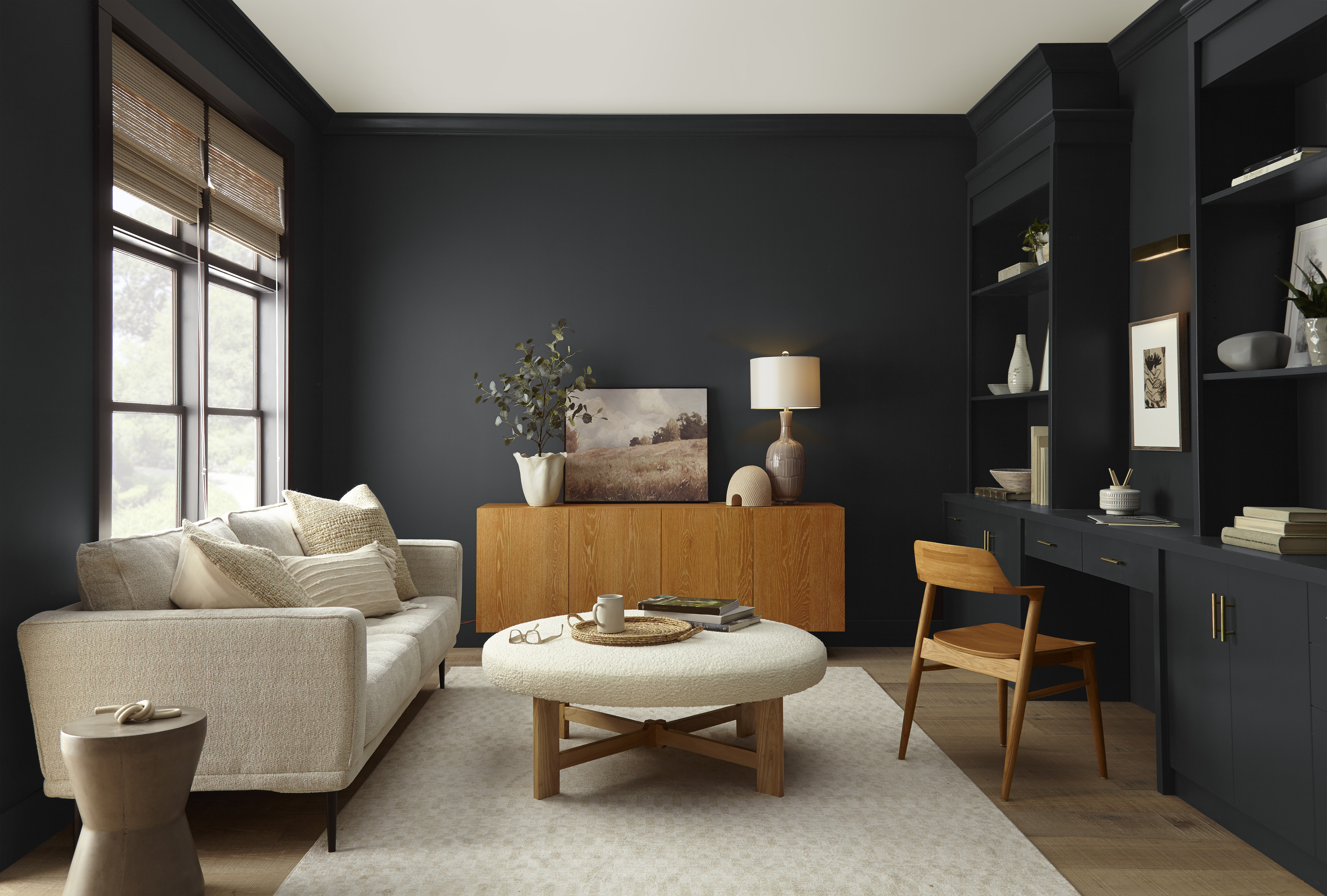 A family room with walls and a built-in floor-to-ceiling cabinet and desk all in the colour Cracked Pepper