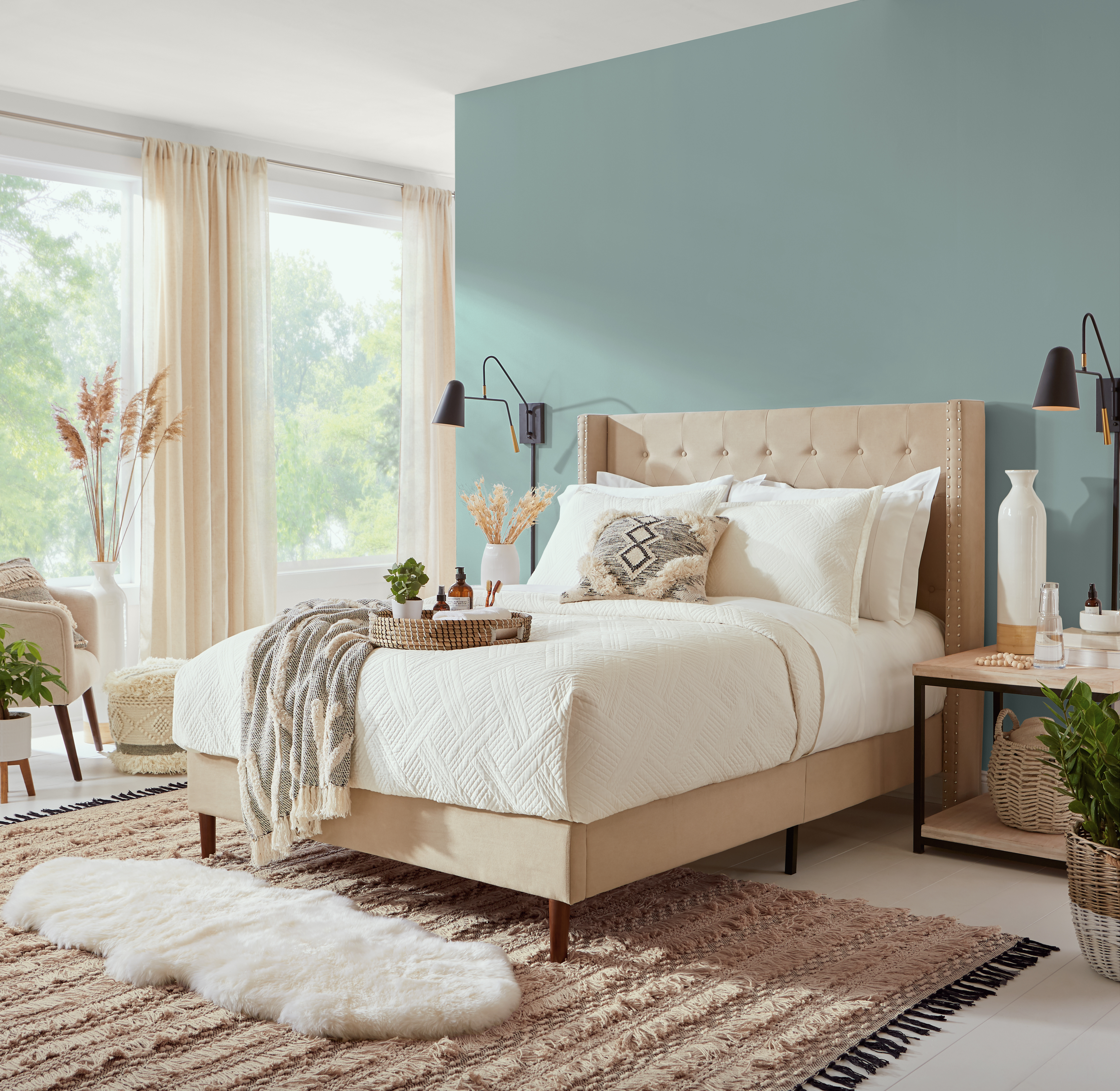 A light-filled bedroom with walls in the colour Whipped Cream and an accent wall in the colour Provence Blue behind the headboard 