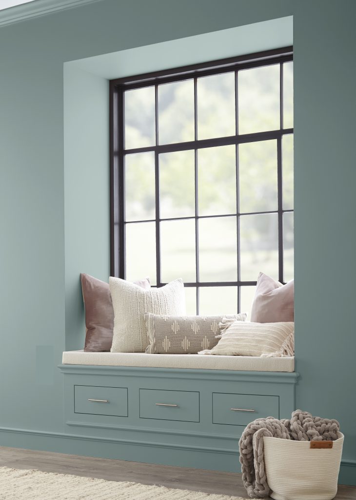 A reading nook area painted in a dusty blue colour