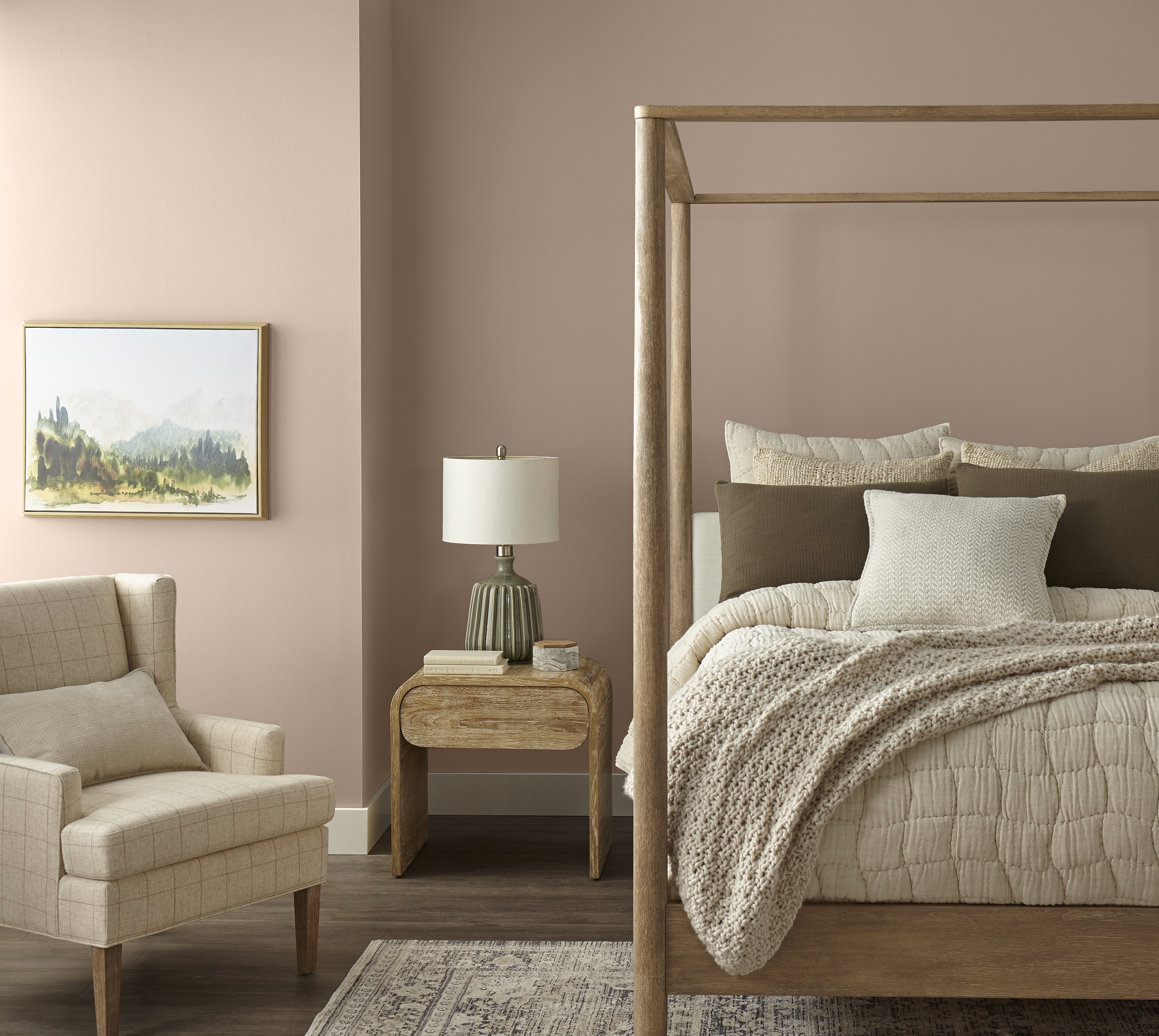 A bedroom with taupe walls, styled with a canopy bed and neutral furniture and décor 