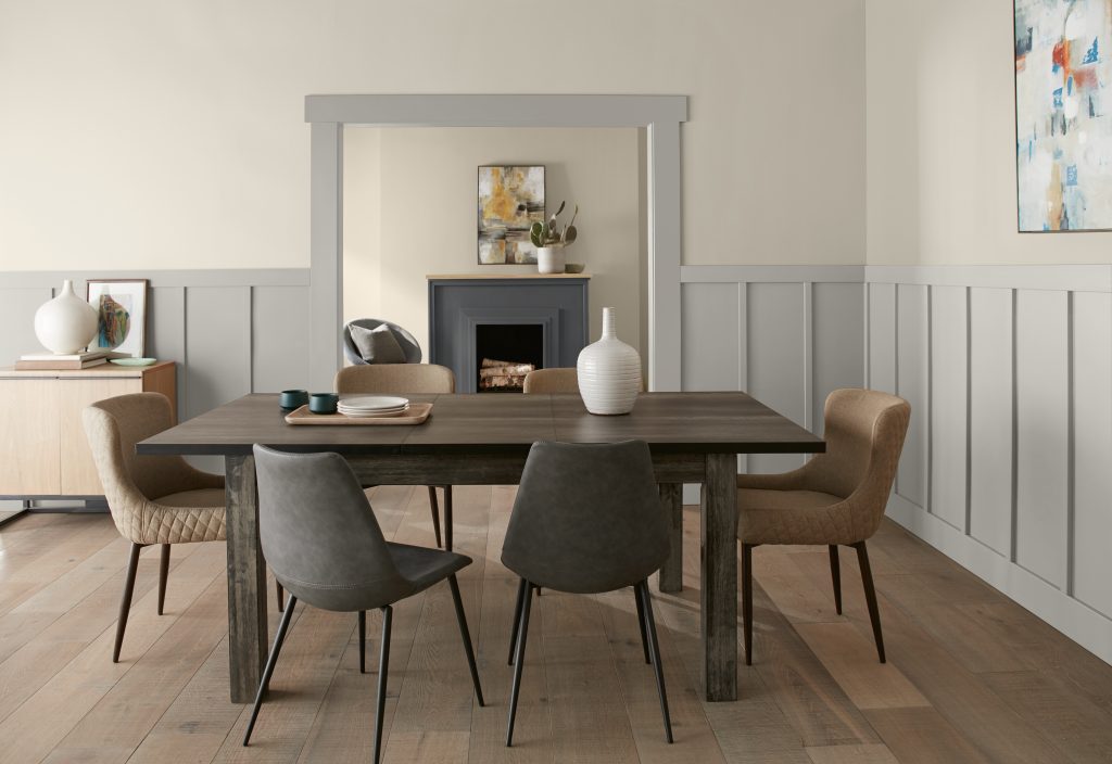 A farmhouse-style dining and living room space with cool and warm neutral tones including greys and creams