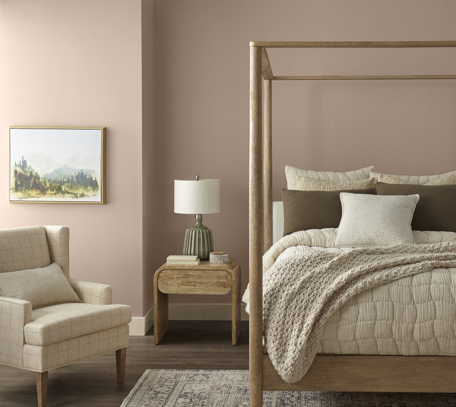 A bedroom with walls painted in a soft brown, styled with a canopy bed and armchair