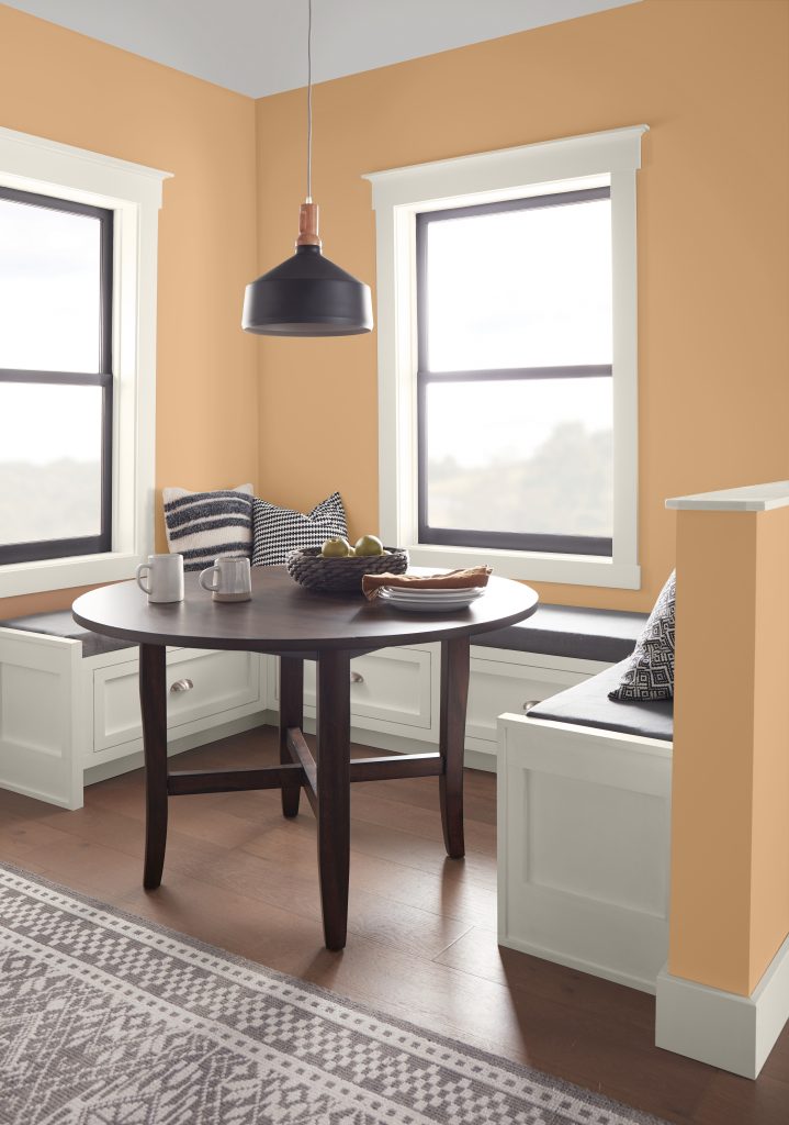 A kitchen nook with the walls painted in a soft orange hue