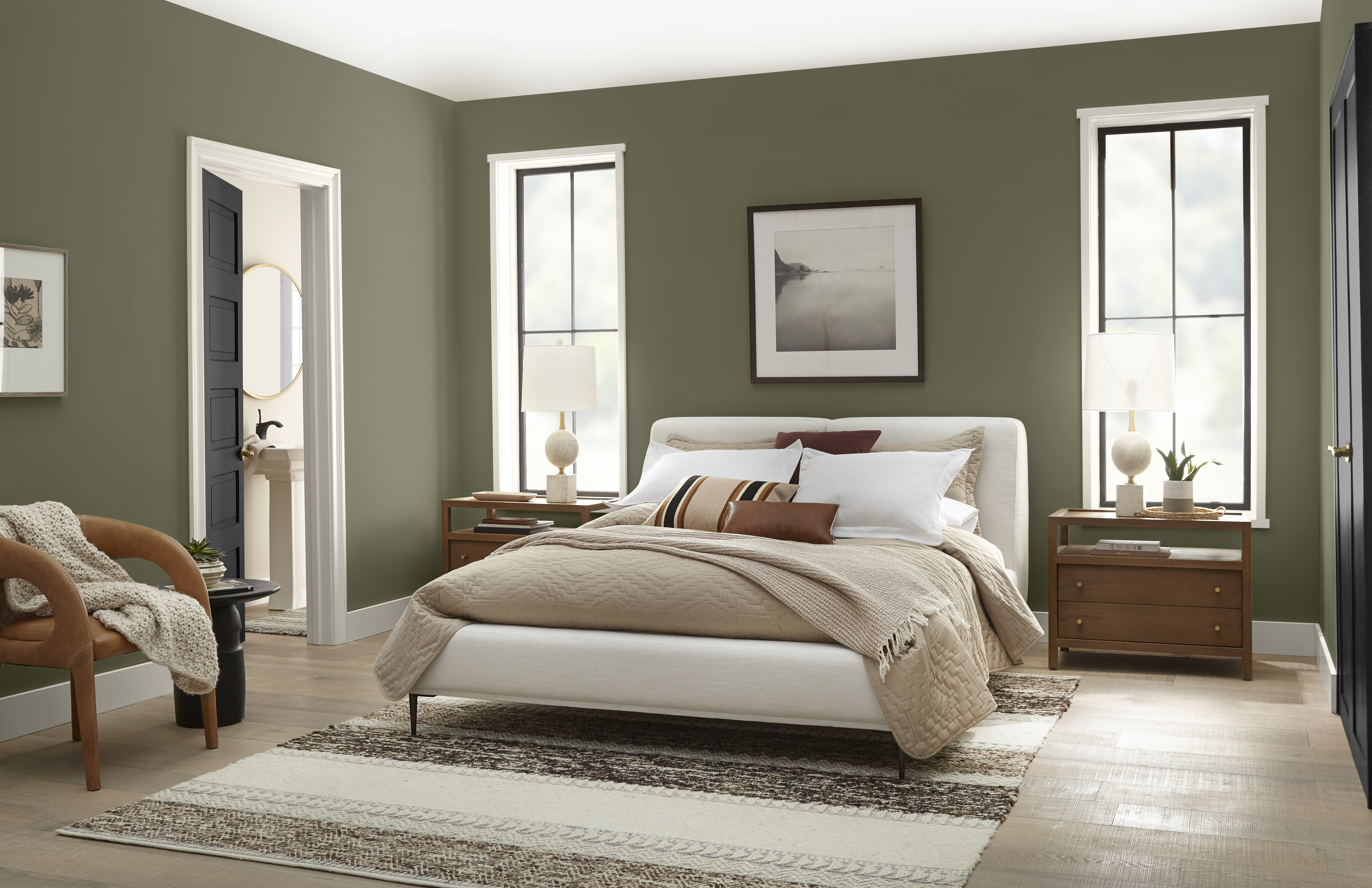 A cozy bedroom with walls painted in warm, dark green colour