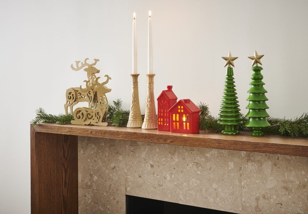 A fireplace mantle with holiday decorations after being spray painted