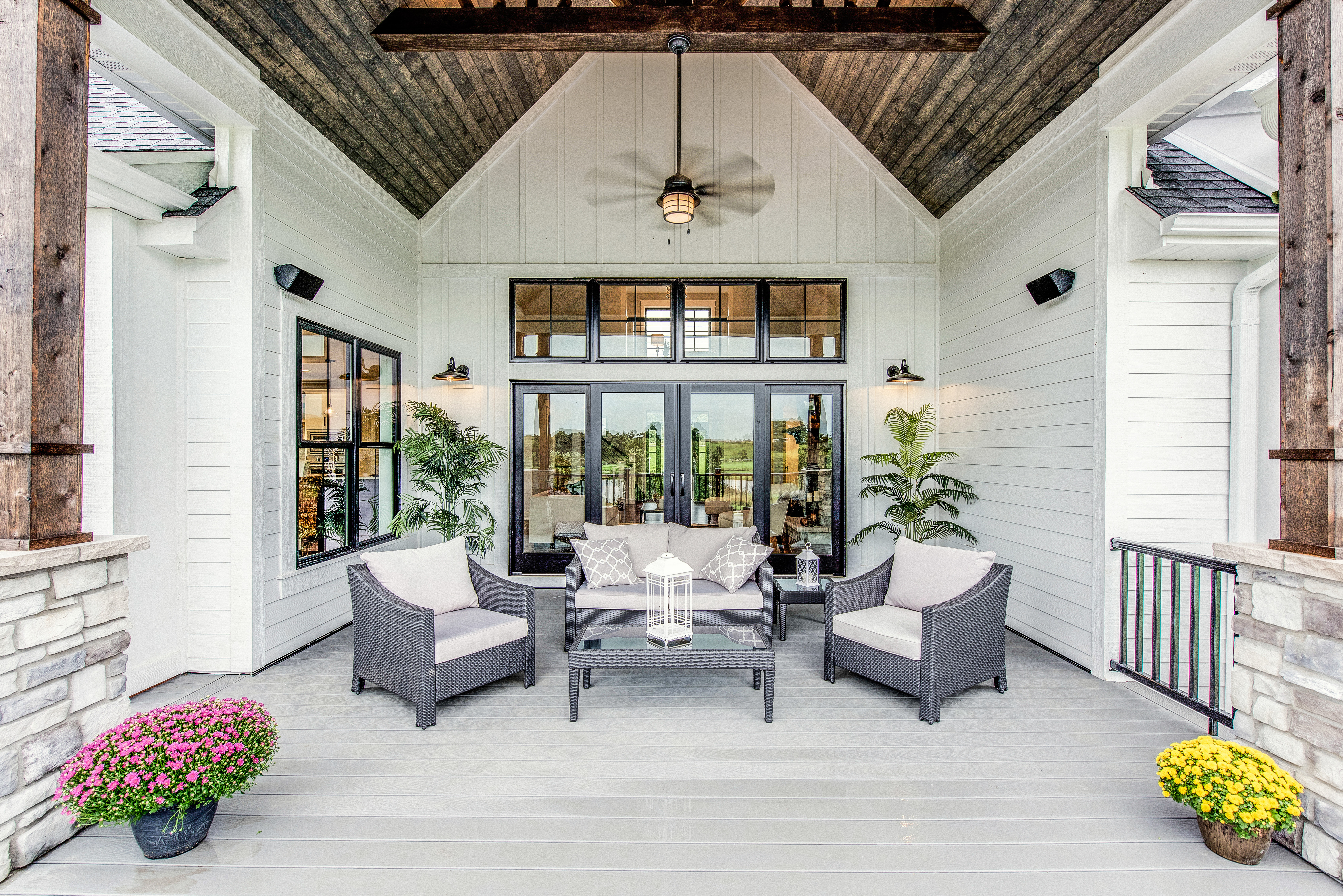An enclosed exterior porch/outdoor living area, showing the house body and trim painted in white