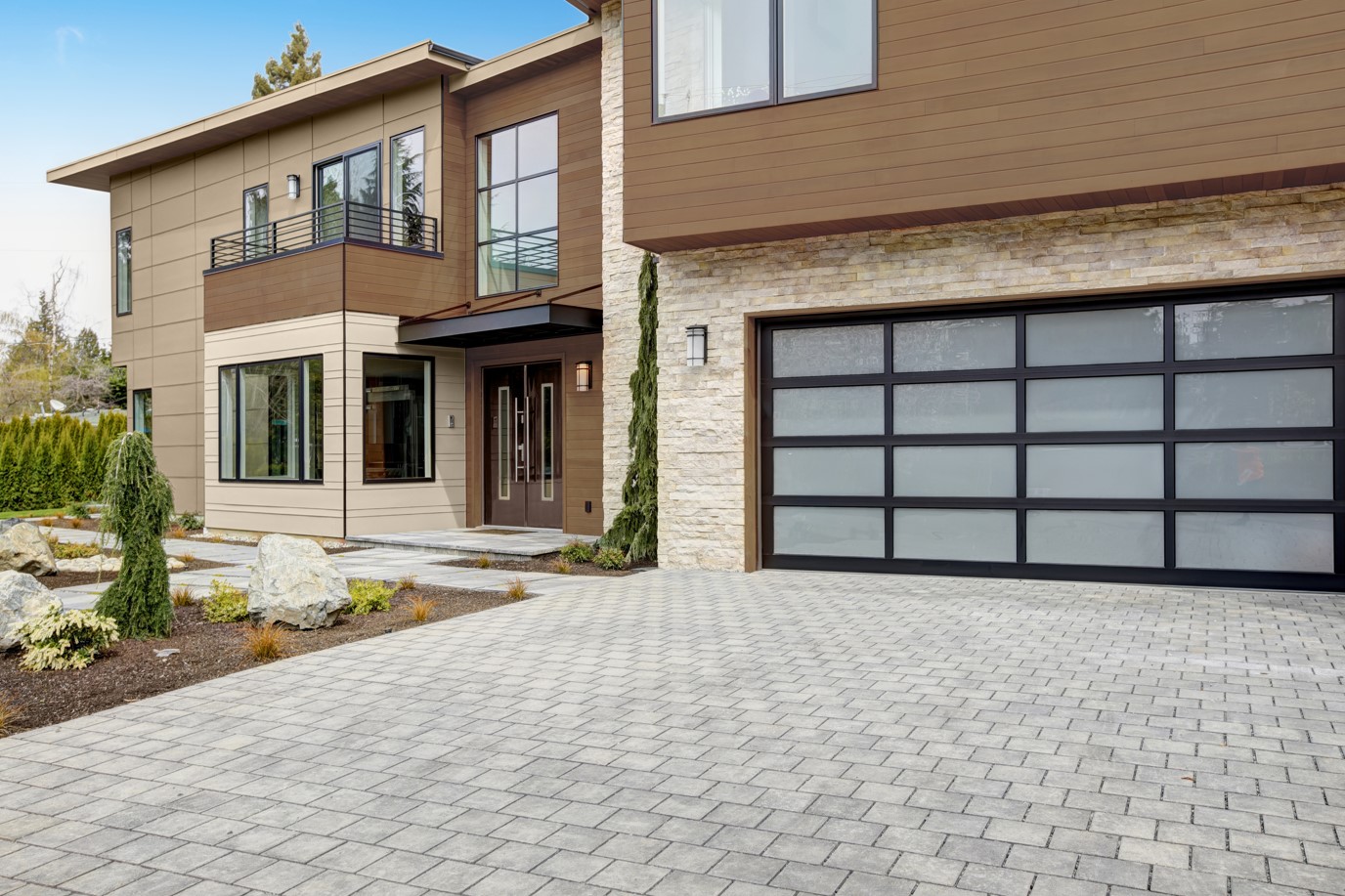 A modern house exterior with brown semi-transparent wood siding