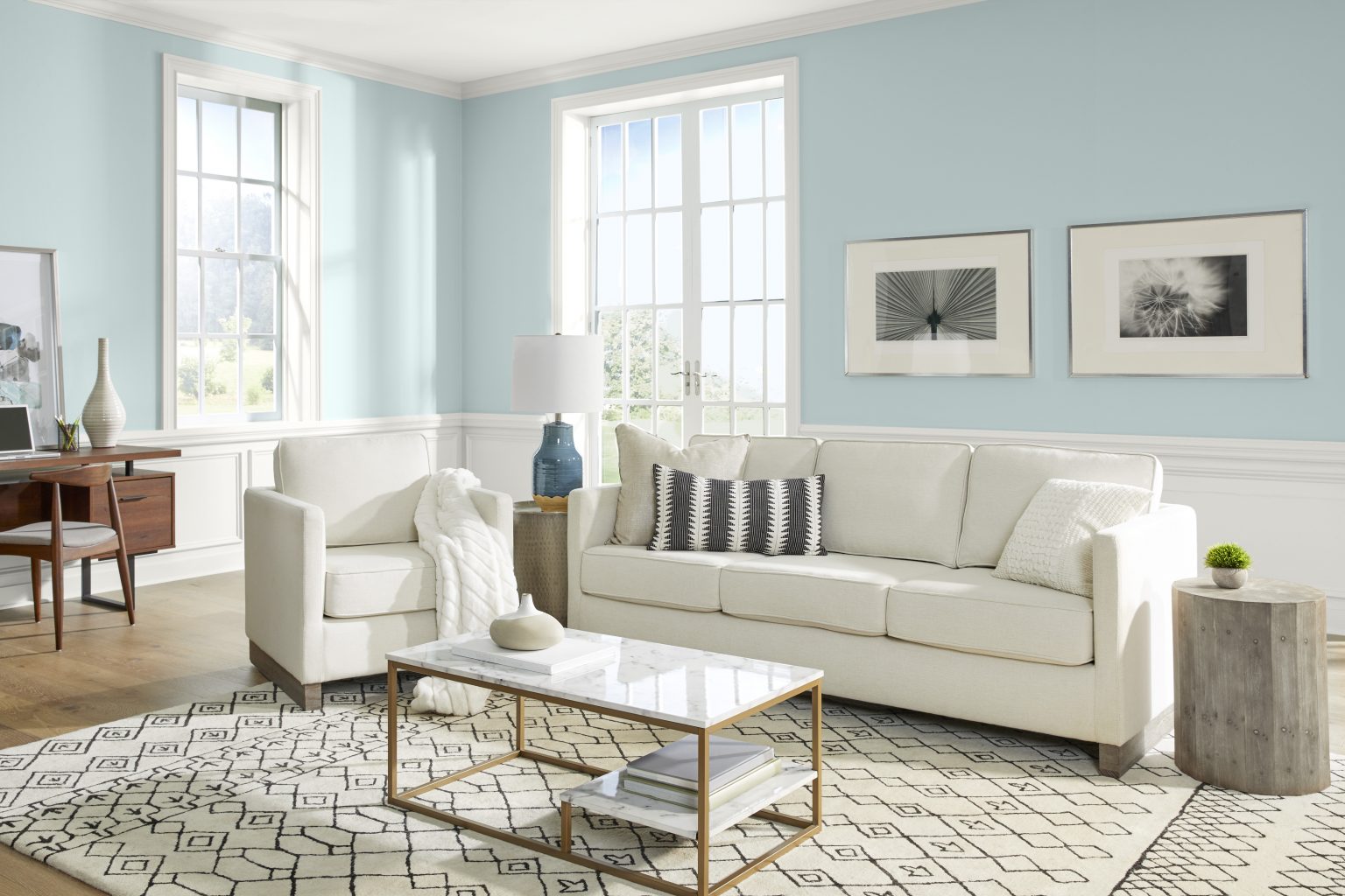 A bright coastal style living room with walls painted in light blue