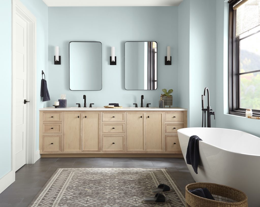 A large spa-like bathroom with walls painted in light blue