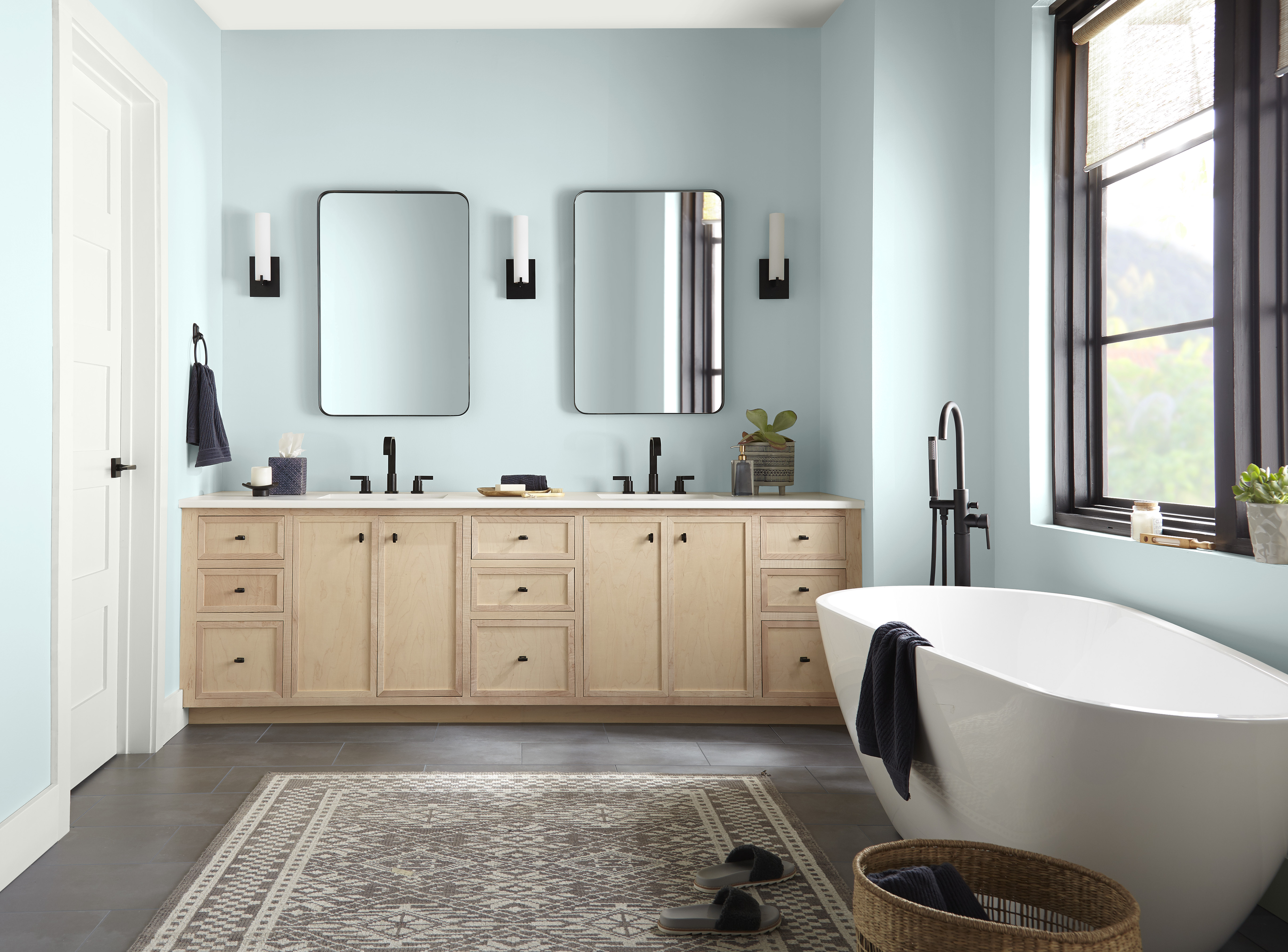 A bright and airy bathroom with walls painted in a light blue colour