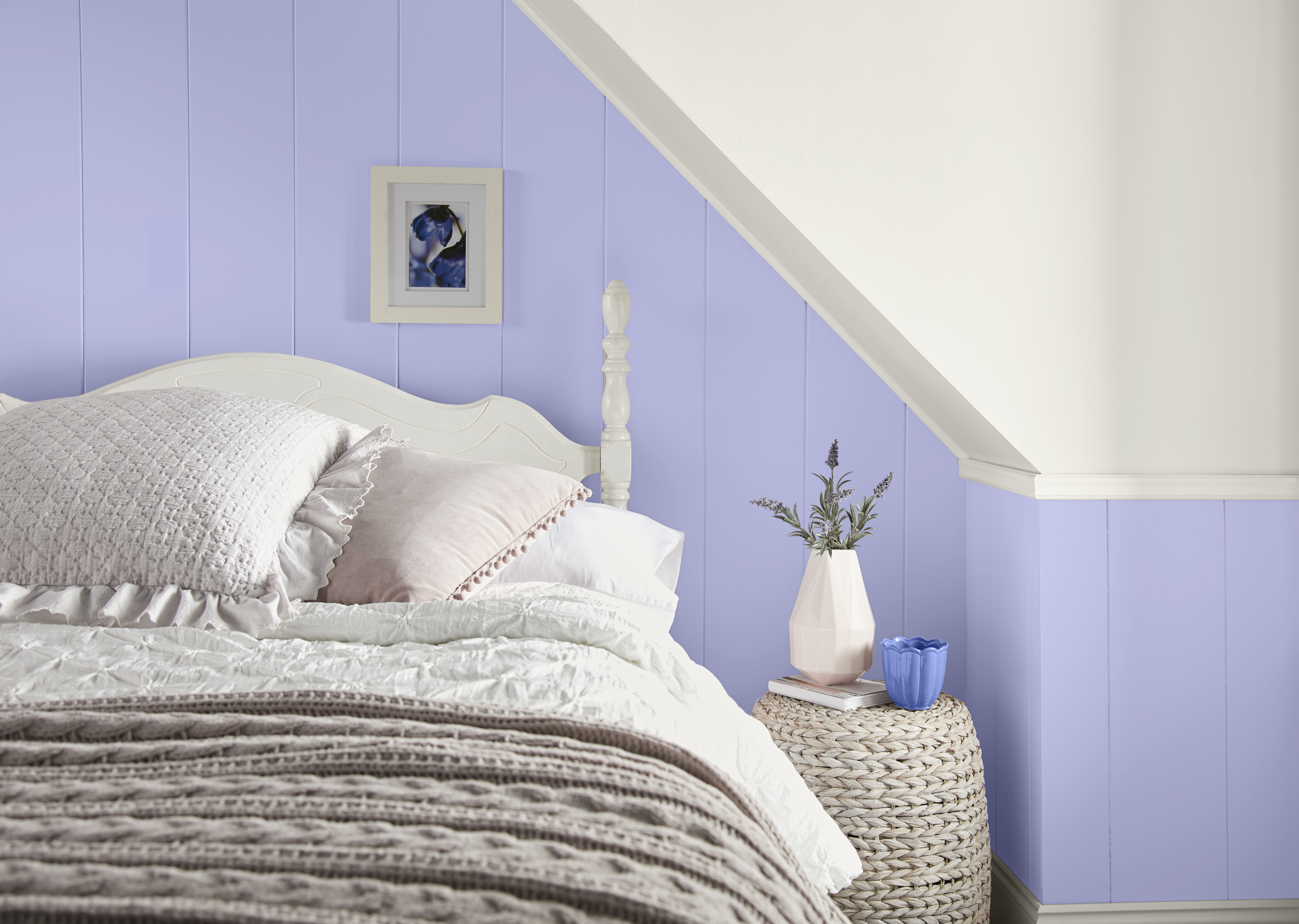 A bedroom with the walls in a purple hue
