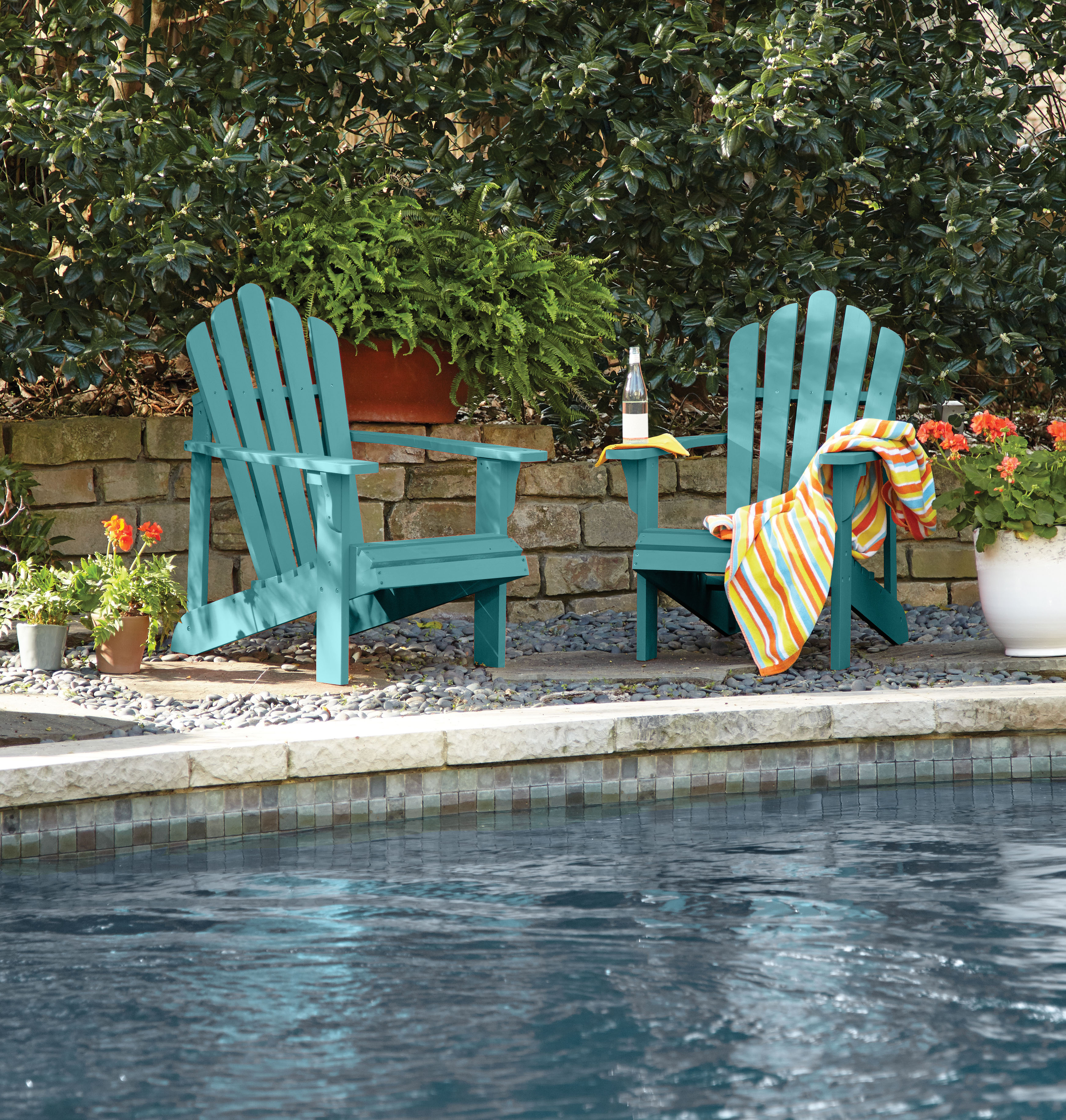 Adirondack style chairs painted in a vibrant blue-green hue.