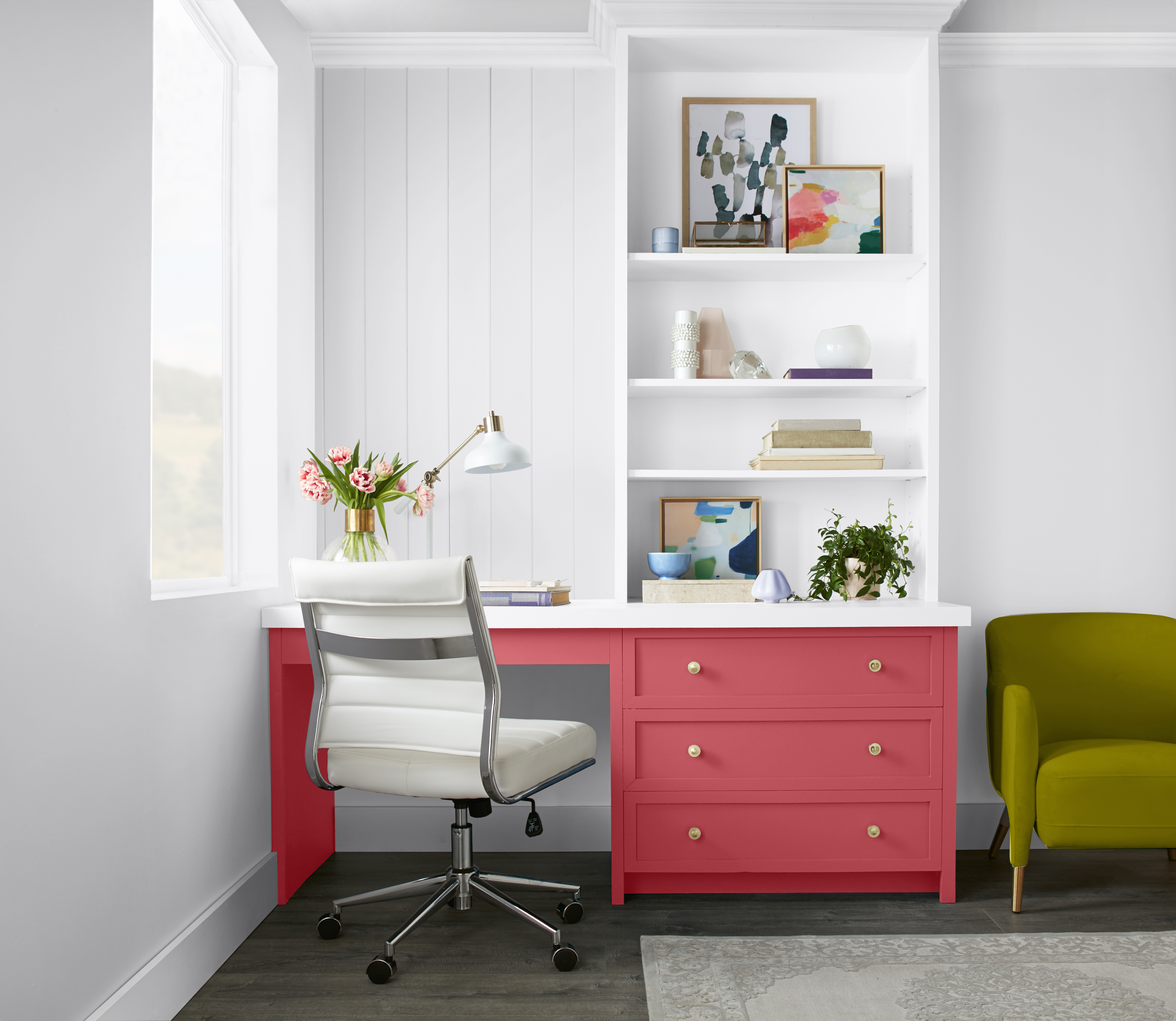 A home office with the desk painted in a vibrant pink hue.