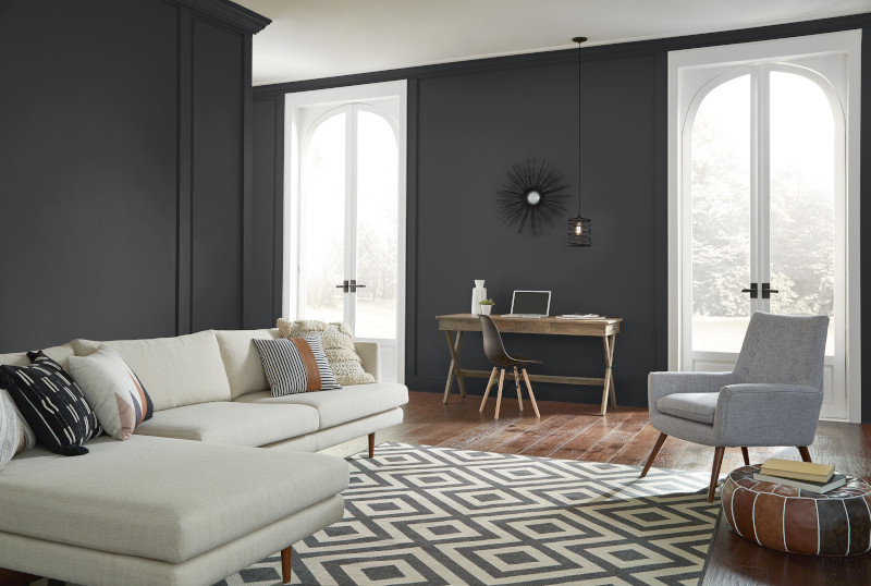 The image features a modern, stylish living room with a cozy yet functional layout.