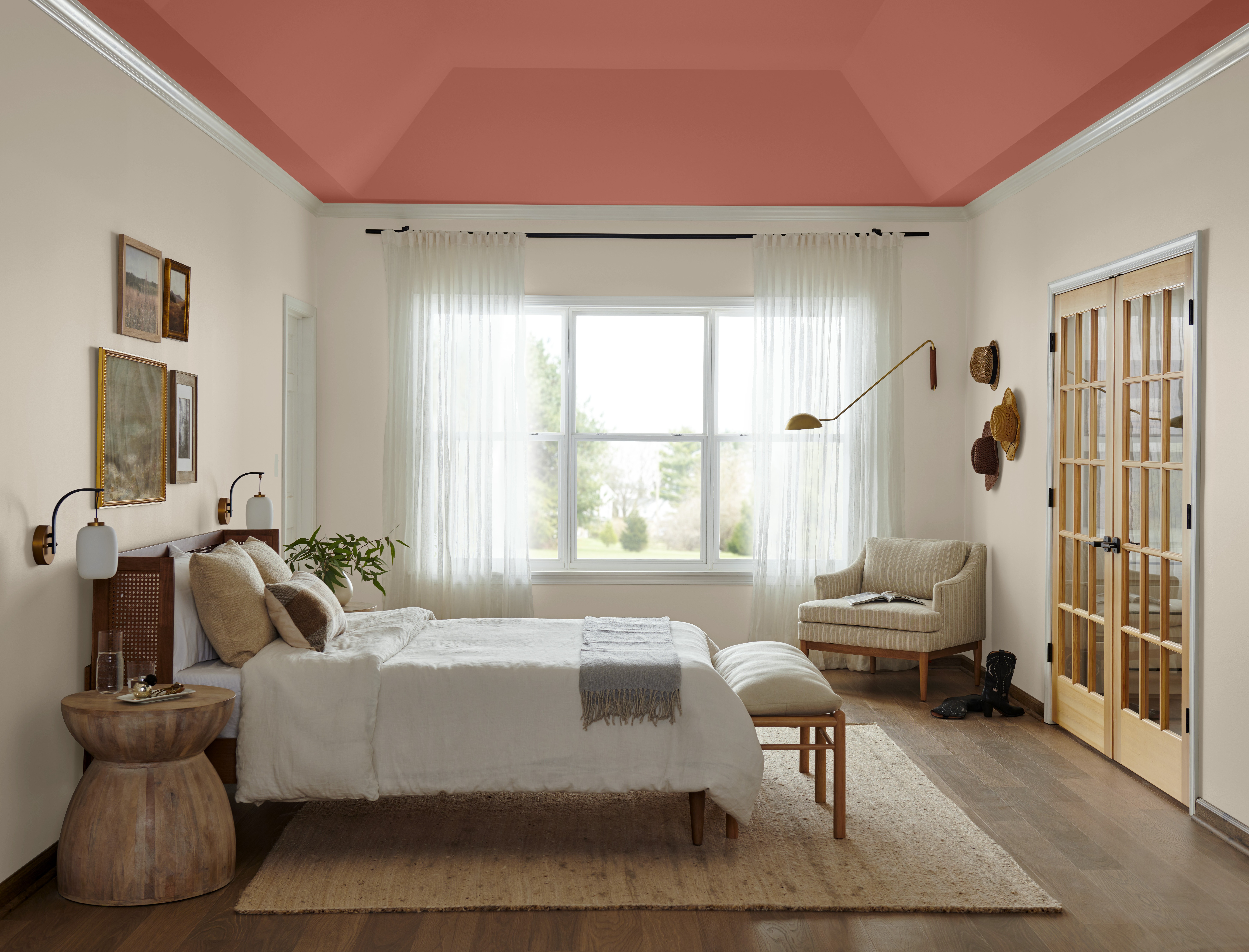 A bedroom with a recessed ceiling and a bed and a chair.