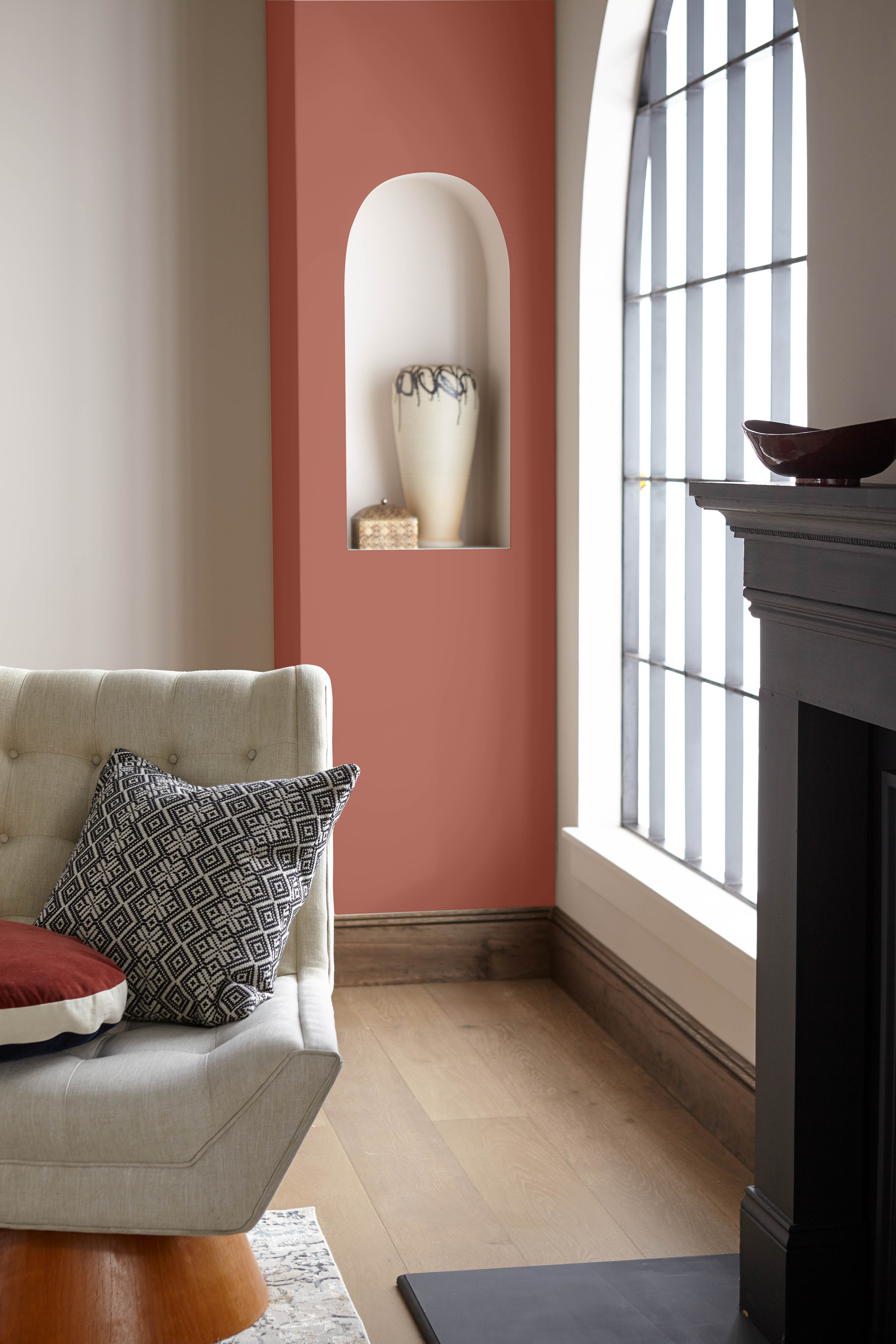 A living room with a fireplace and a red wall