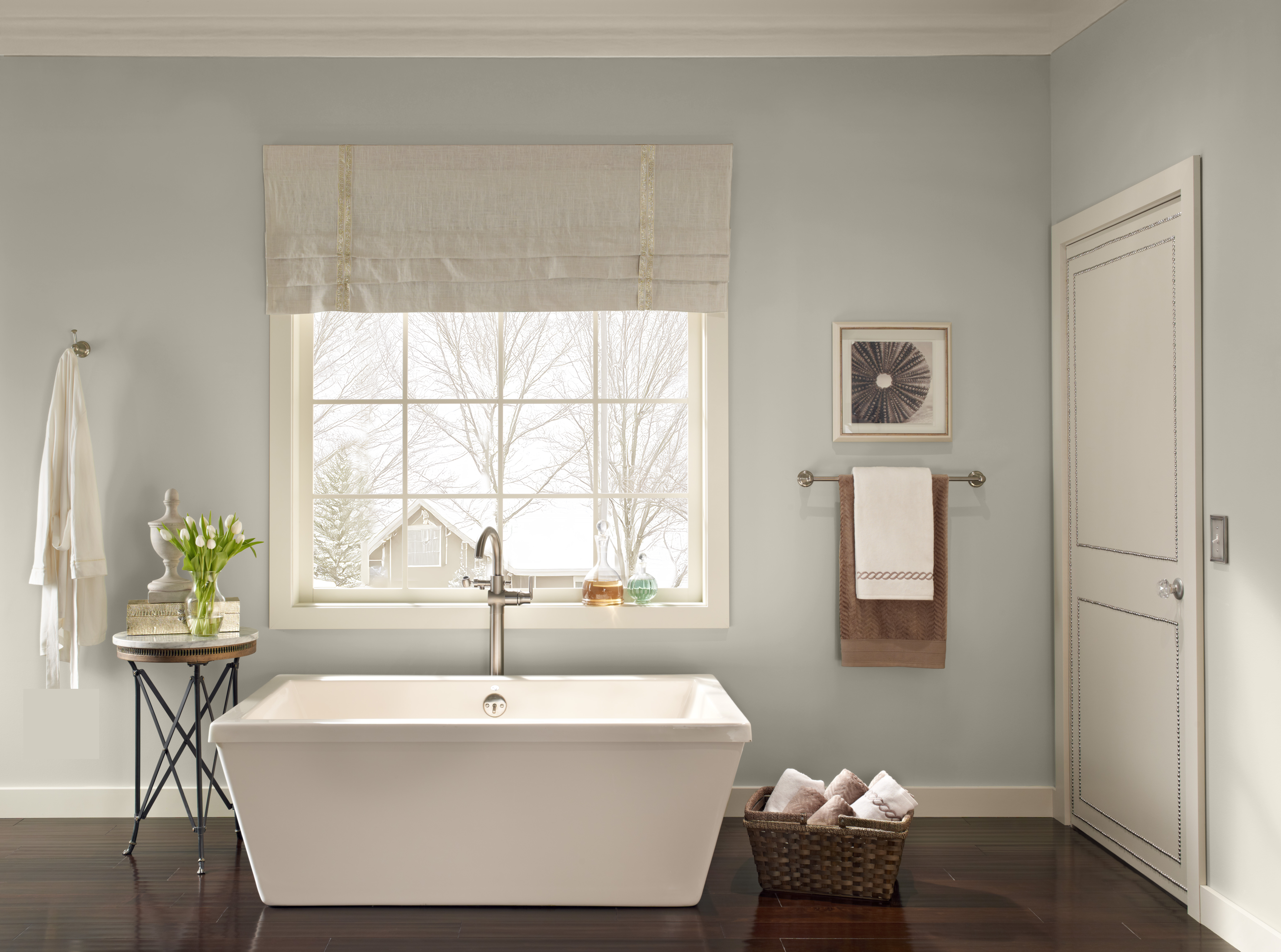 A bathroom with a soft and soothing grey hue painted on the walls.