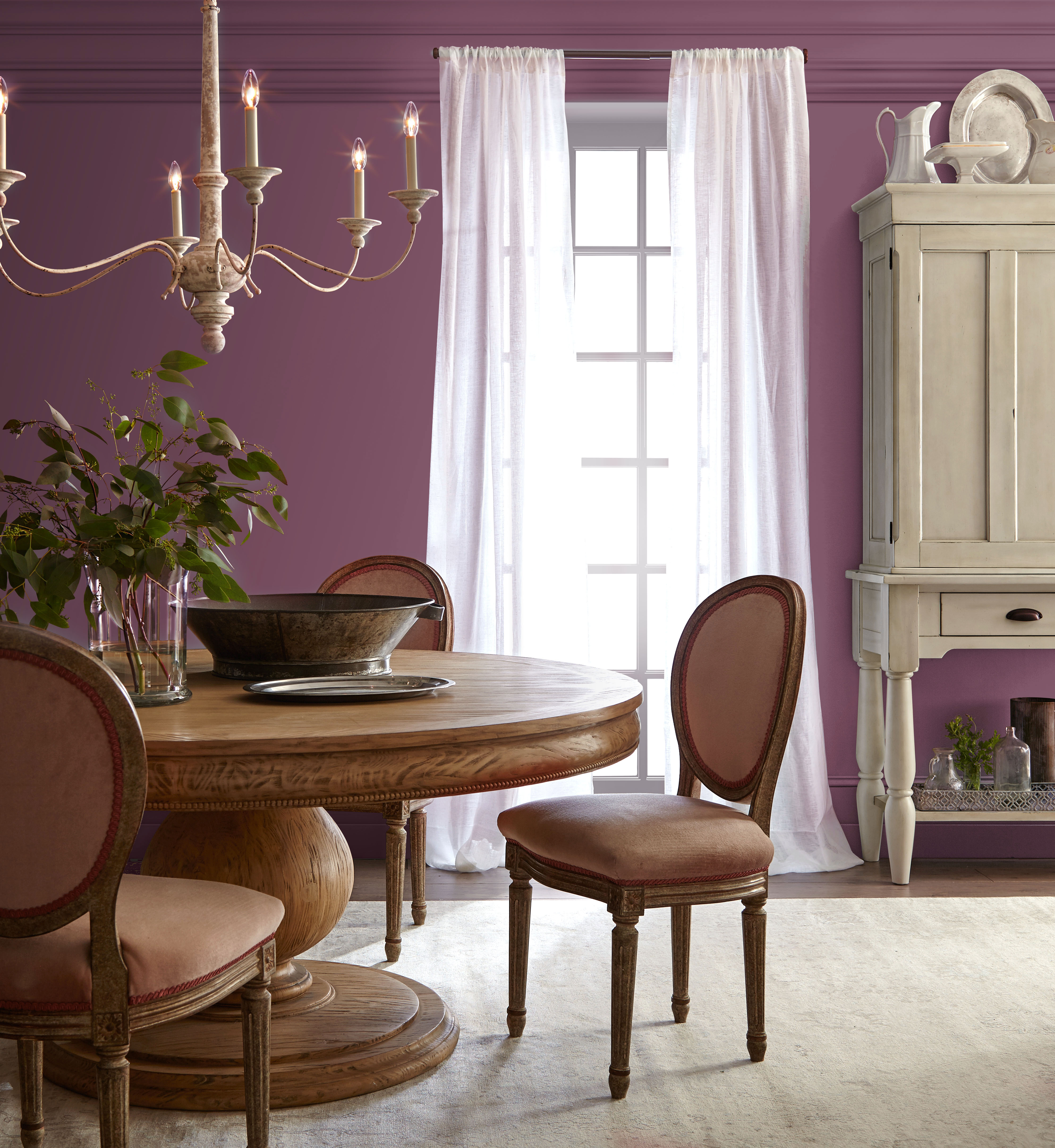 Dining room wrapped in a deep, wine-like hue that creates a rich, intimate atmosphere.