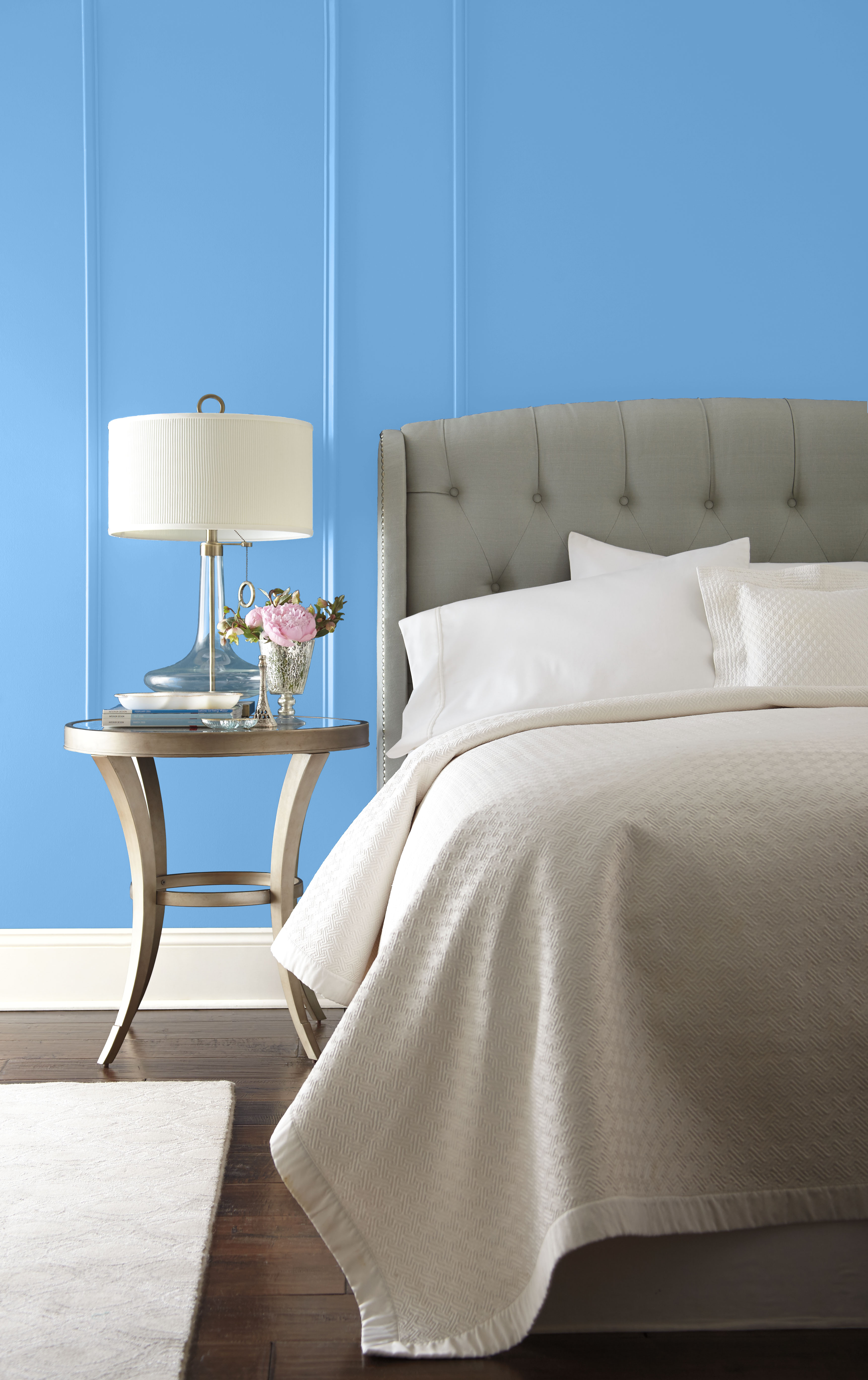 Bedroom finished in a cool, clear blue hue that feels calming and timeless, with furnishings playing a quiet supporting role.