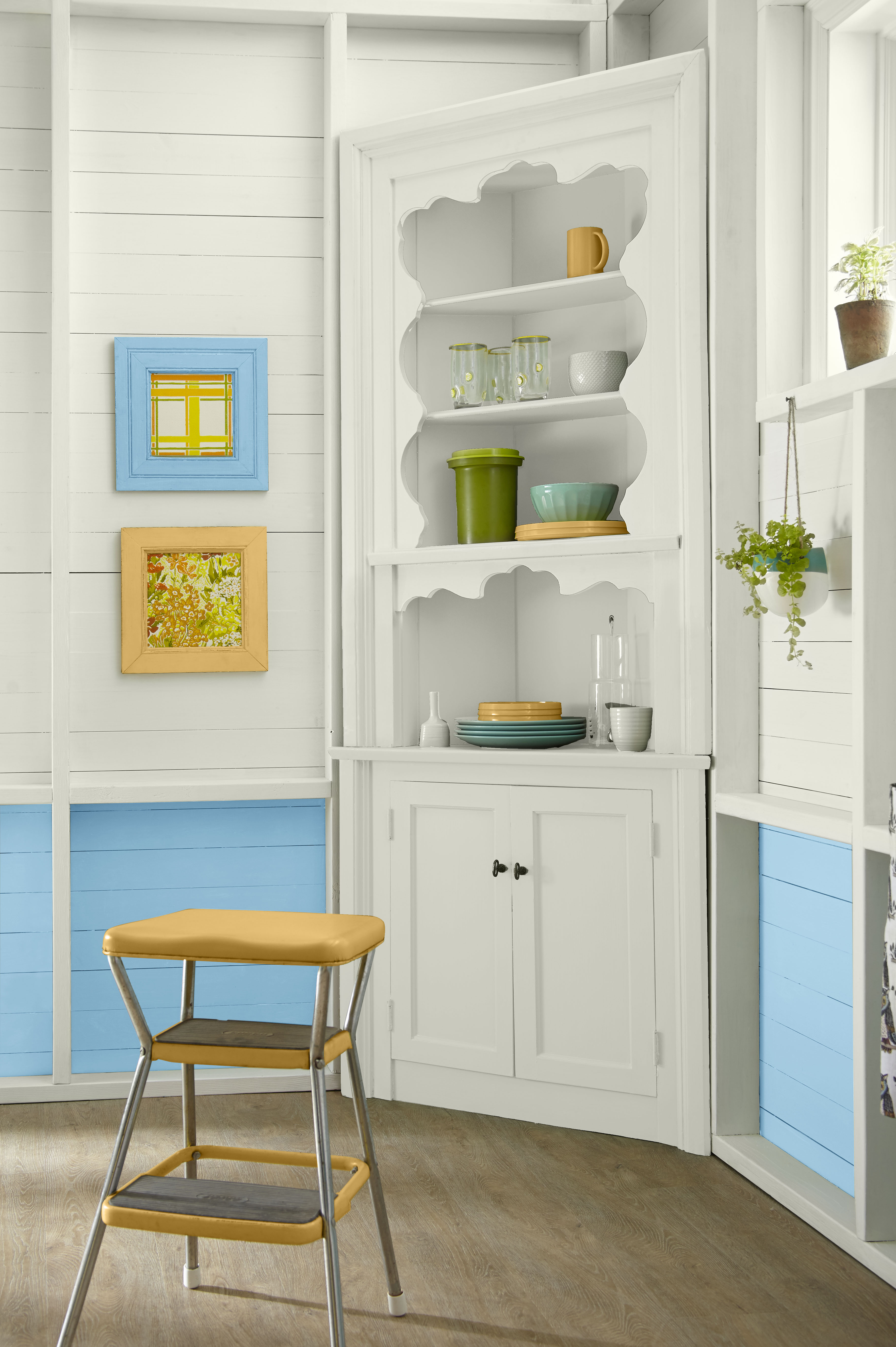 Breakfast nook painted in a soft, airy blue-leaning tone that brightens the space and gently frames the surrounding architectural details.