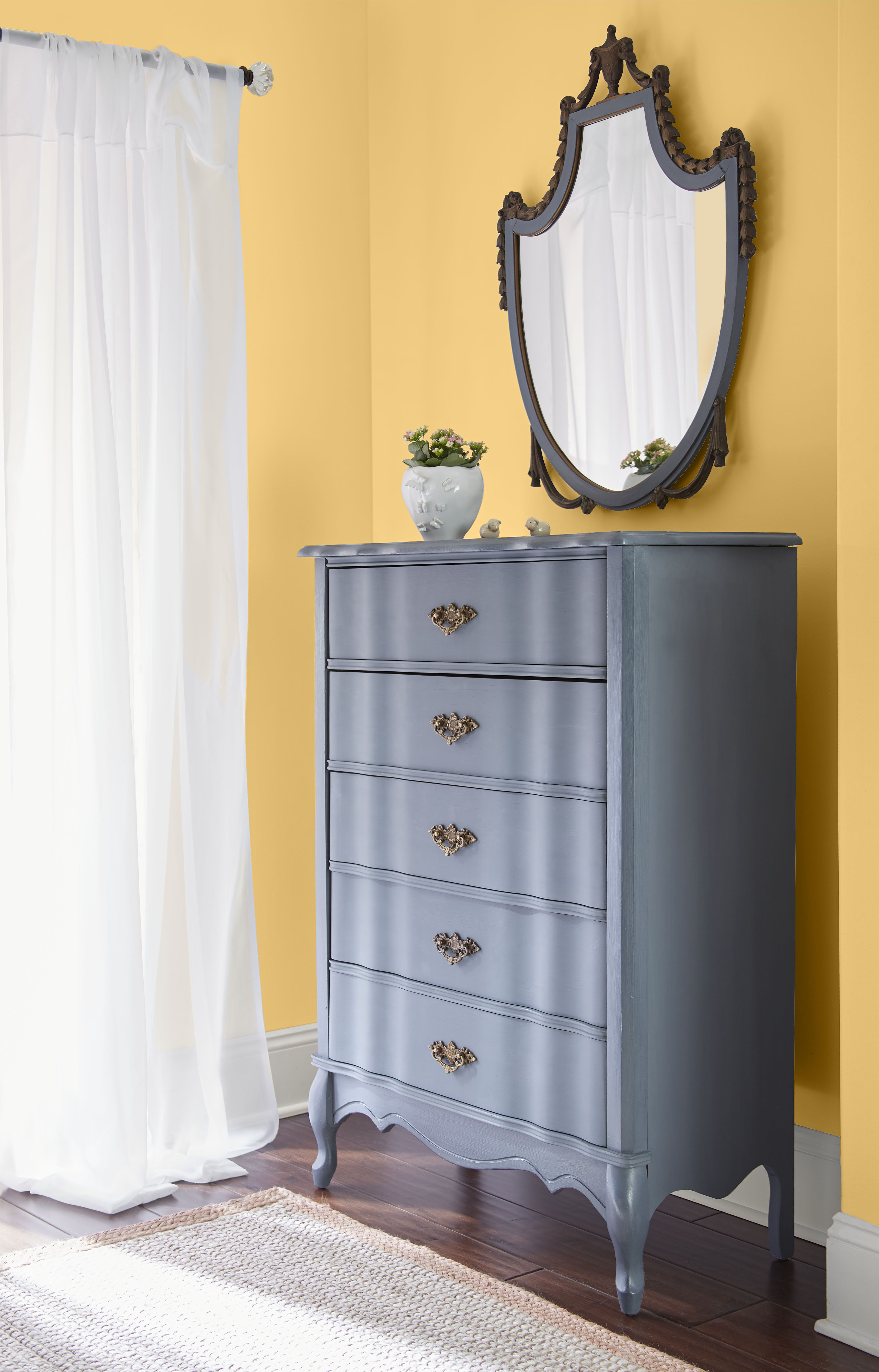 Bedroom coated in a warm, golden-mustard-inspired shade that energizes the space.