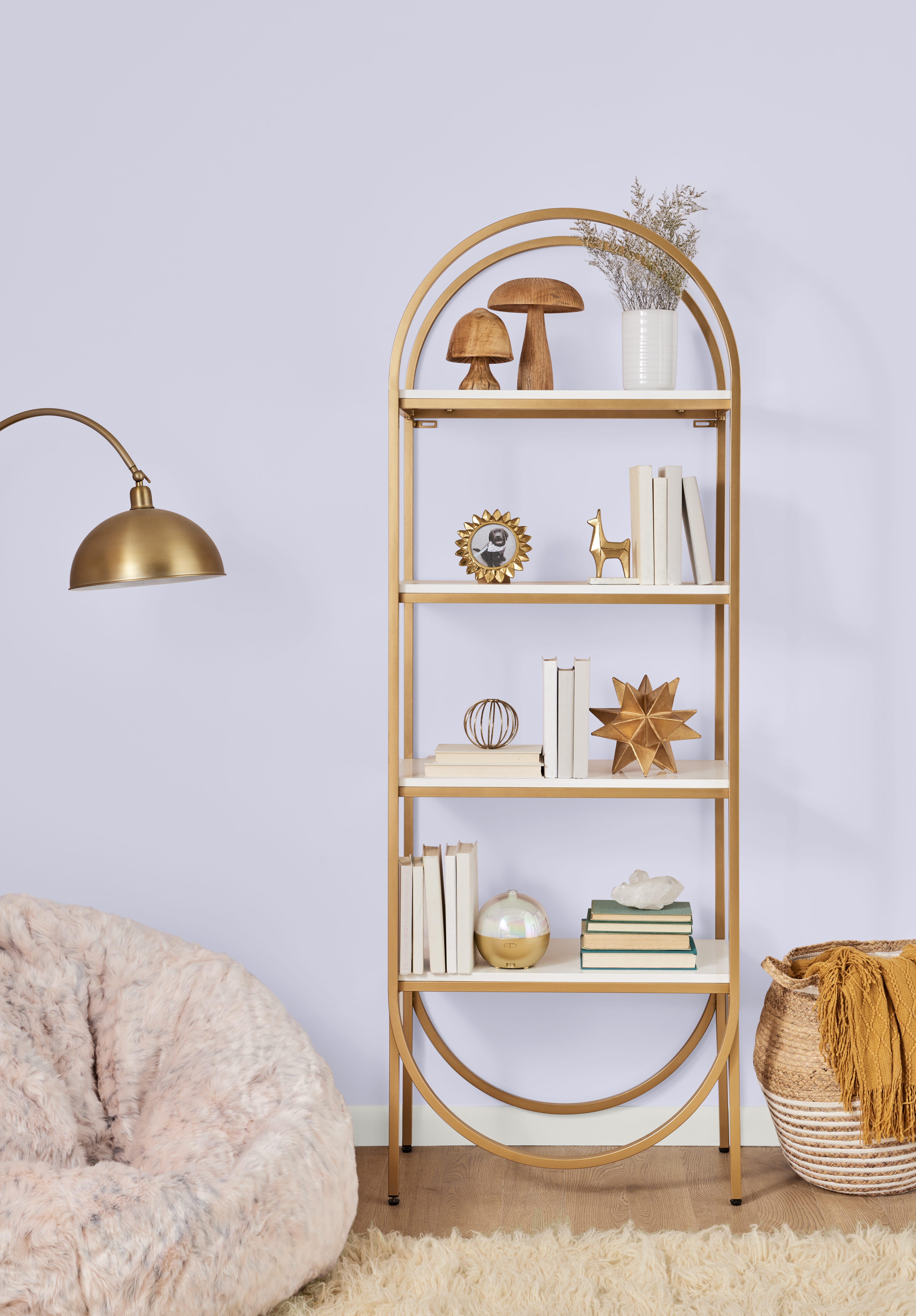 Lavender painted wall in Lavender Memory M550-2 styled with gold shelving, soft neutrals and cozy decor.