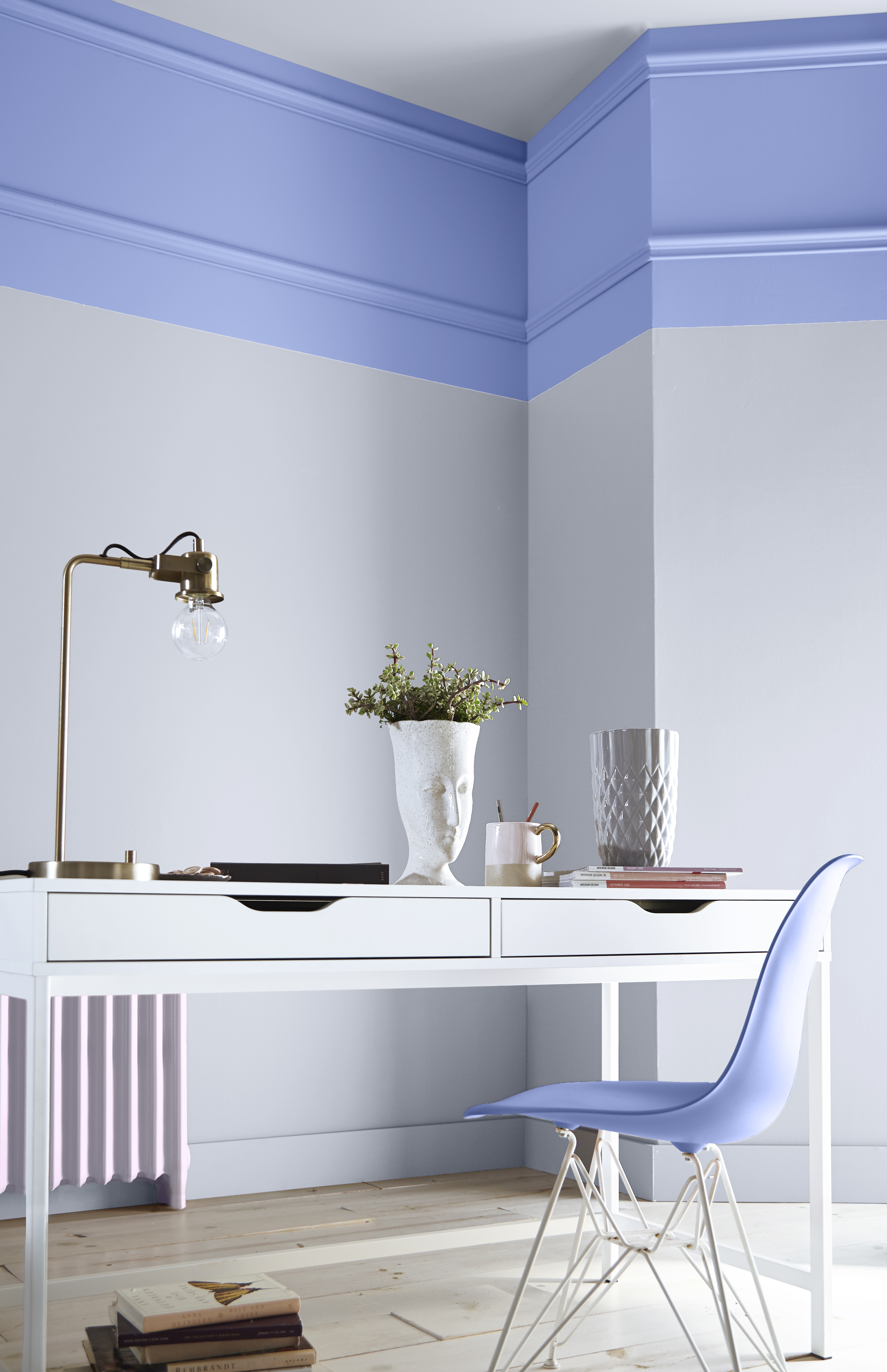 Creative desk nook with lavender-blue Lavender Sky P540-4 walls, white furniture and soft pastel accents.