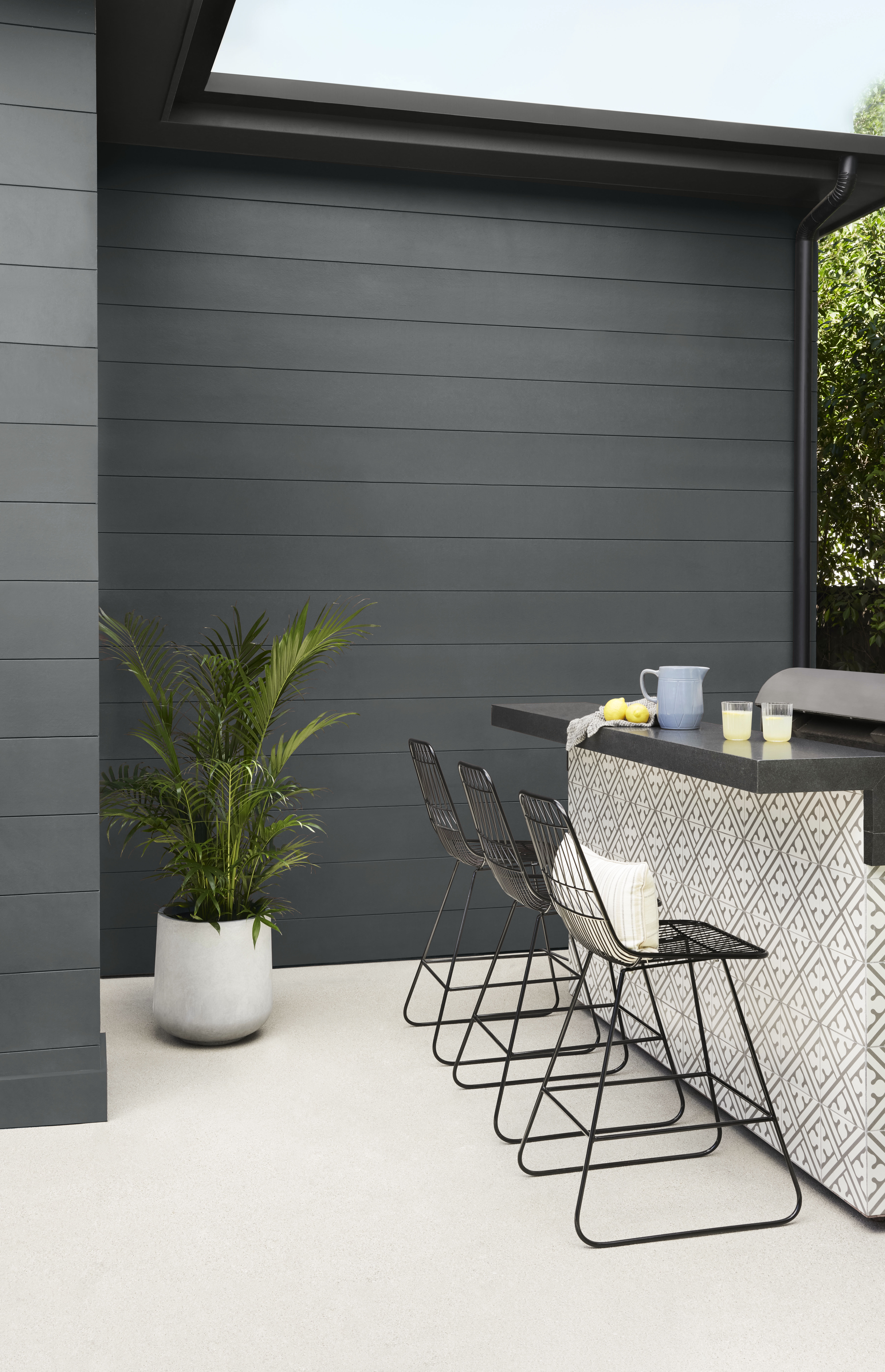 A compact outdoor setting with a dark, earthy exterior that adds depth and a sense of intimacy to the space.