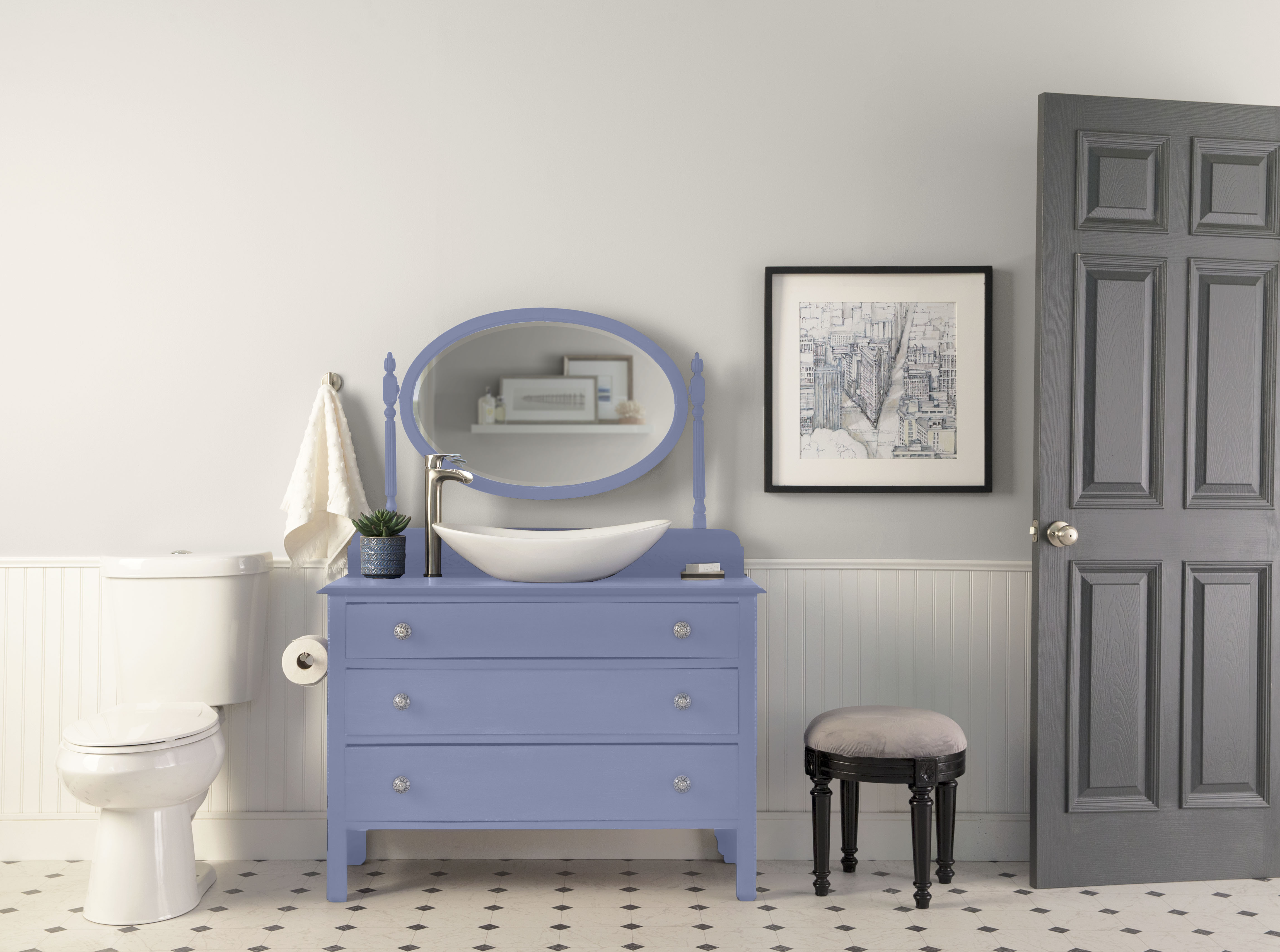 Bathroom with Cameo White soft neutral walls, white wainscoting, Vintage Ribbon blue painted vanity, grey door, patterned floor tile, and vintage-inspired accents for a romantic bathroom paint colour idea.