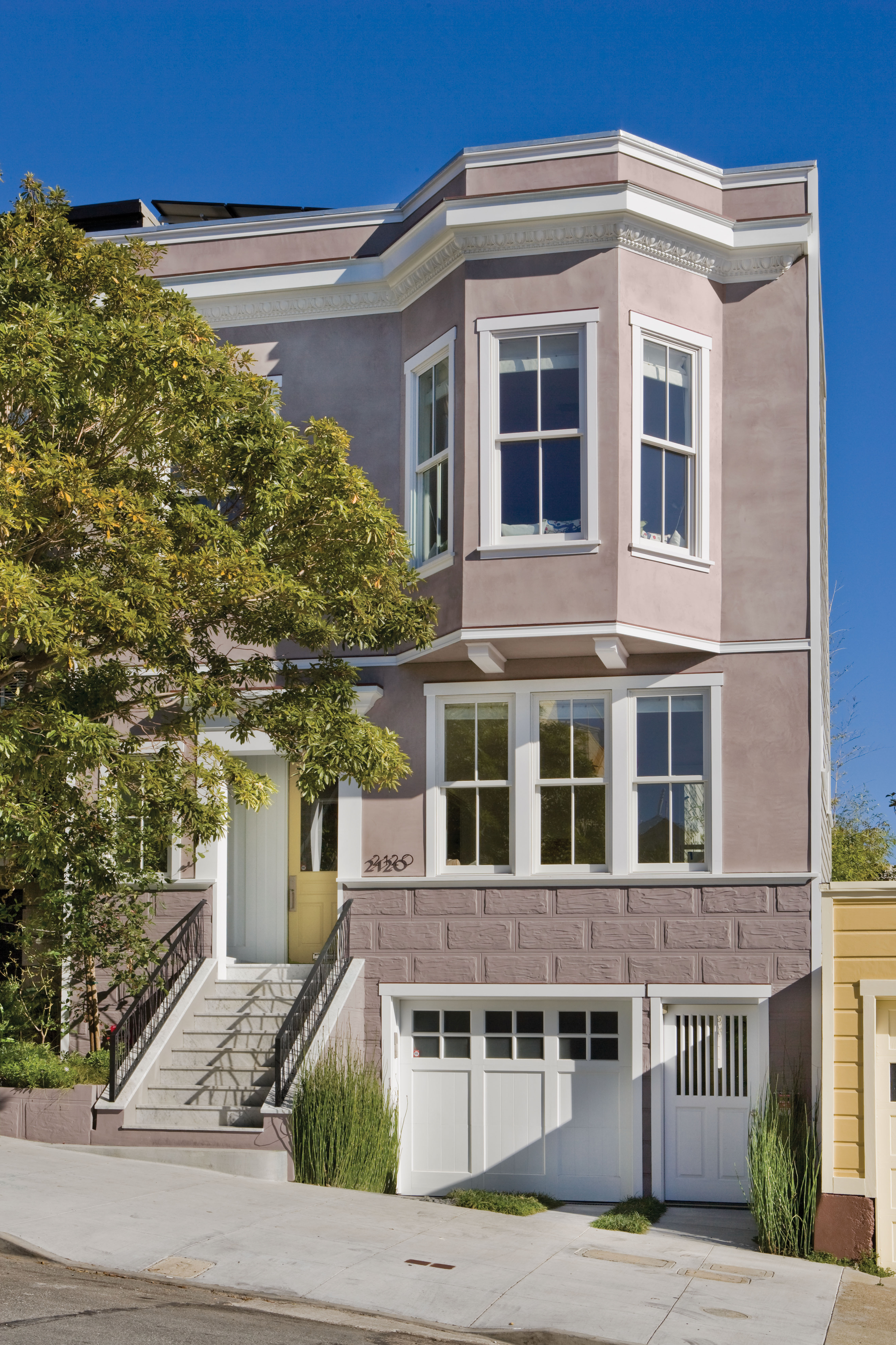 Exterior home painted in Vintage Tea Rose with Cameo White trim, white-framed windows, and classic architectural details for a romantic Regency-inspired exterior colour palette.