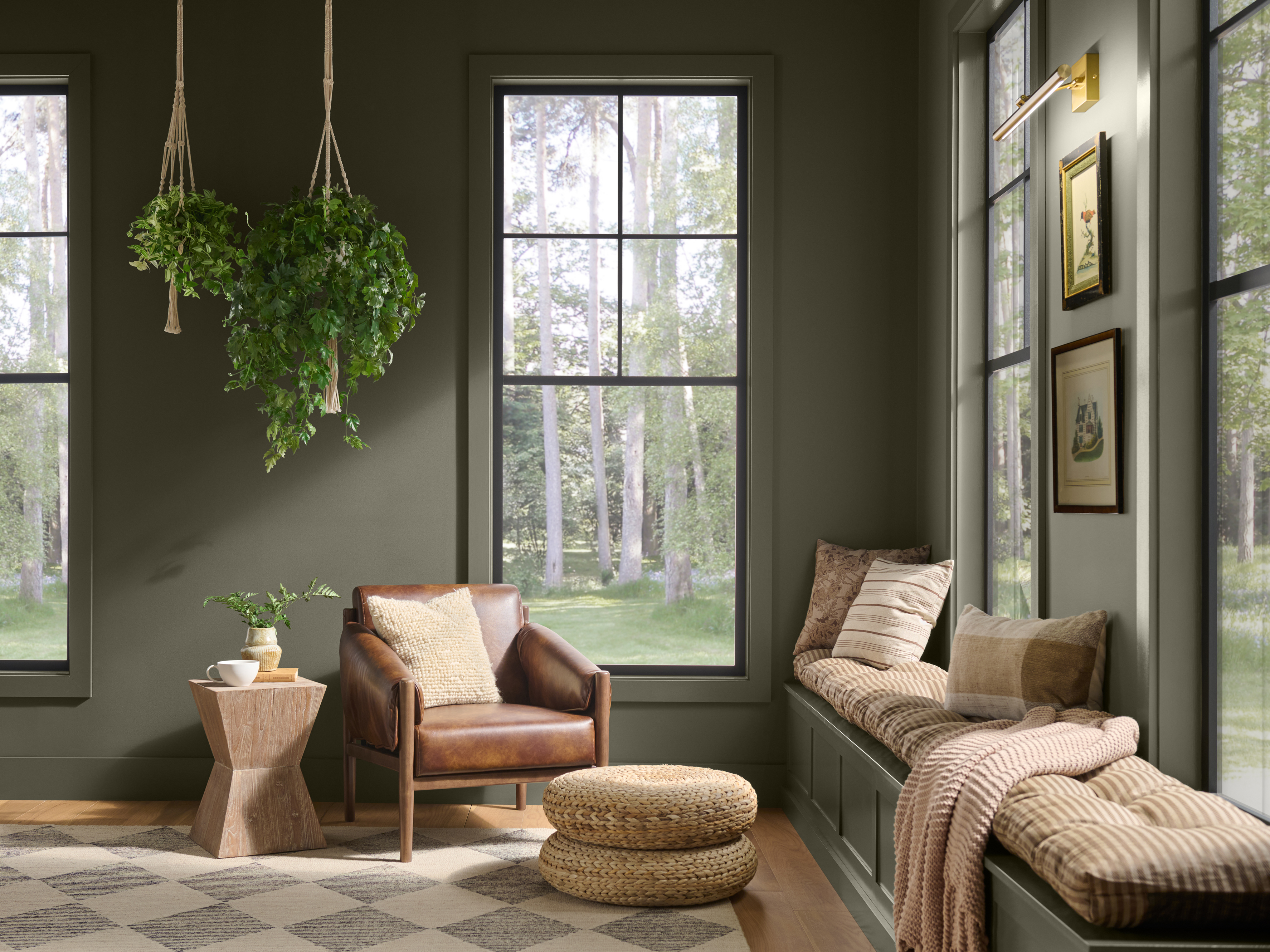 Sunroom with walls and paneled ceiling painted Grounded T27-01, a mossy olive green with earthy brown undertones, paired with natural wood, woven textures, and greenery.